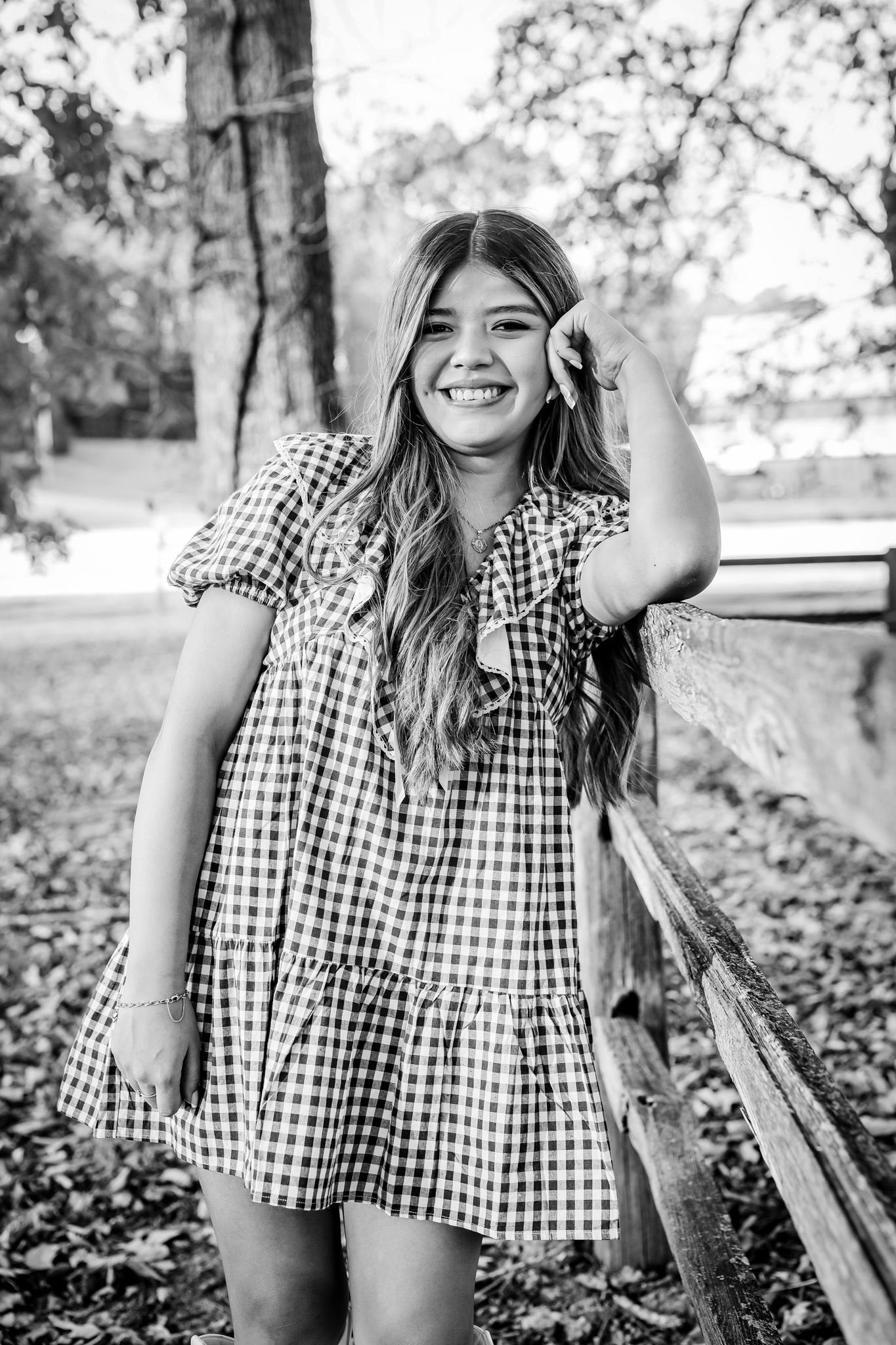 Black and white portraits showing joyful expressions in gingham dress outdoors.