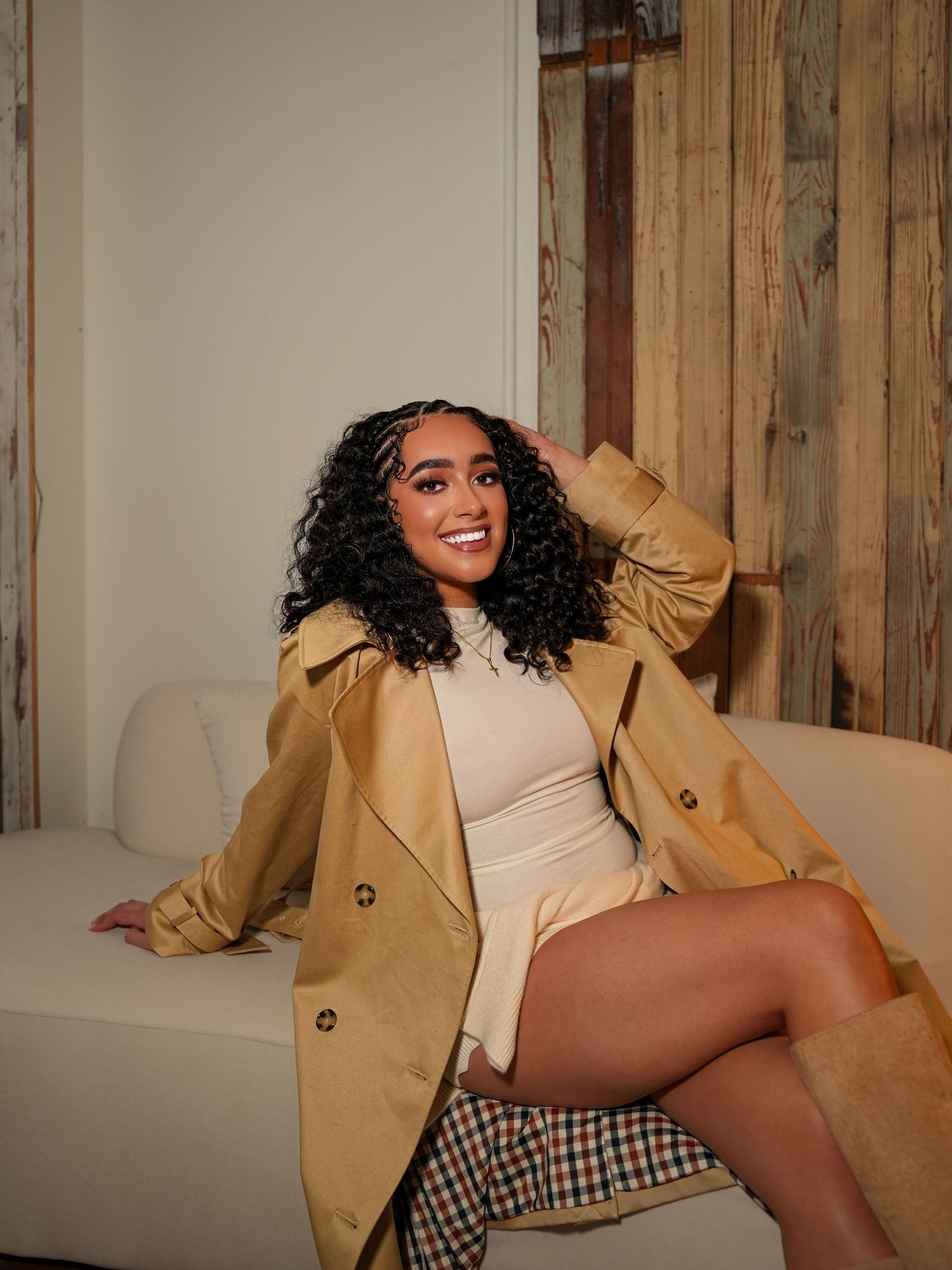 Fashion portraits featuring tan coat and patterned clothing against wooden wall backdrop.