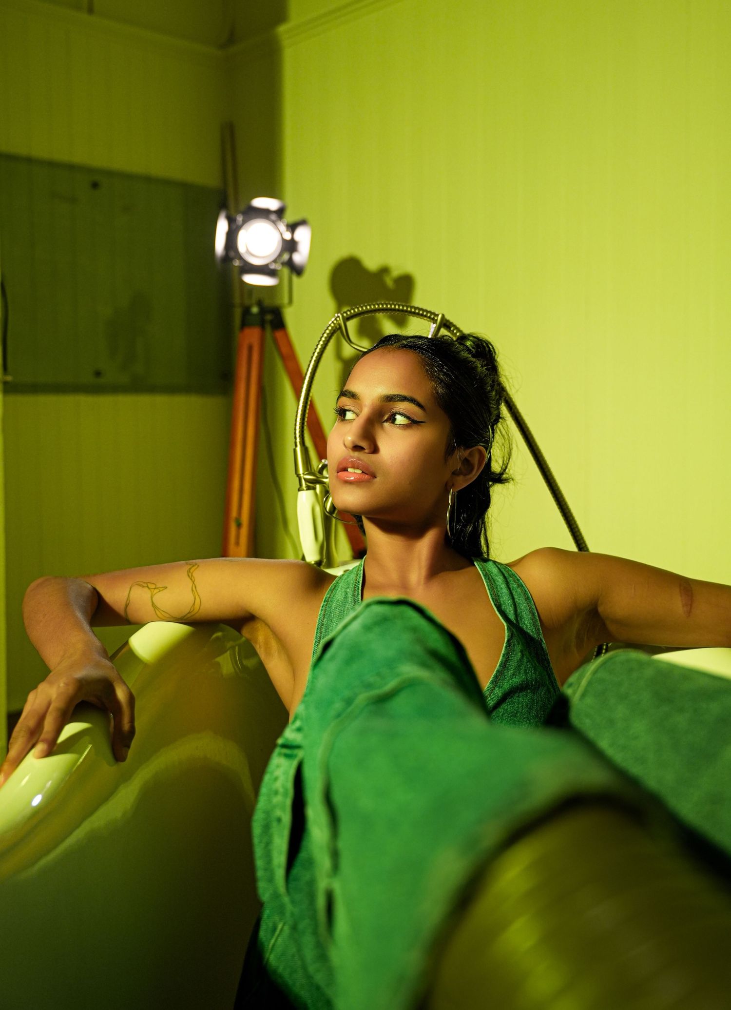 Artistic portraits with dramatic green lighting creating a moody atmosphere.