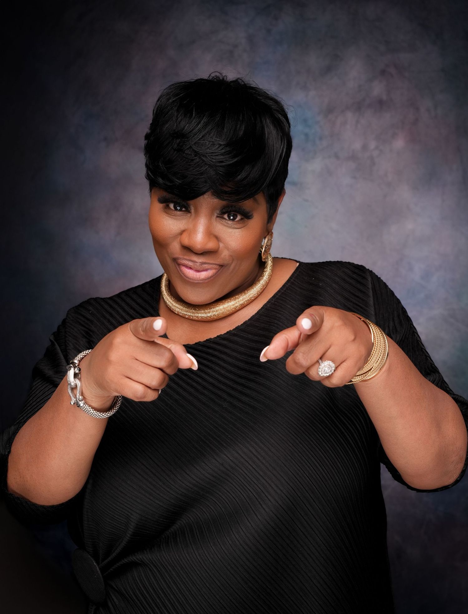 A series of black and white portraits showing someone in a black top making playful hand gestures against a textured backdrop.