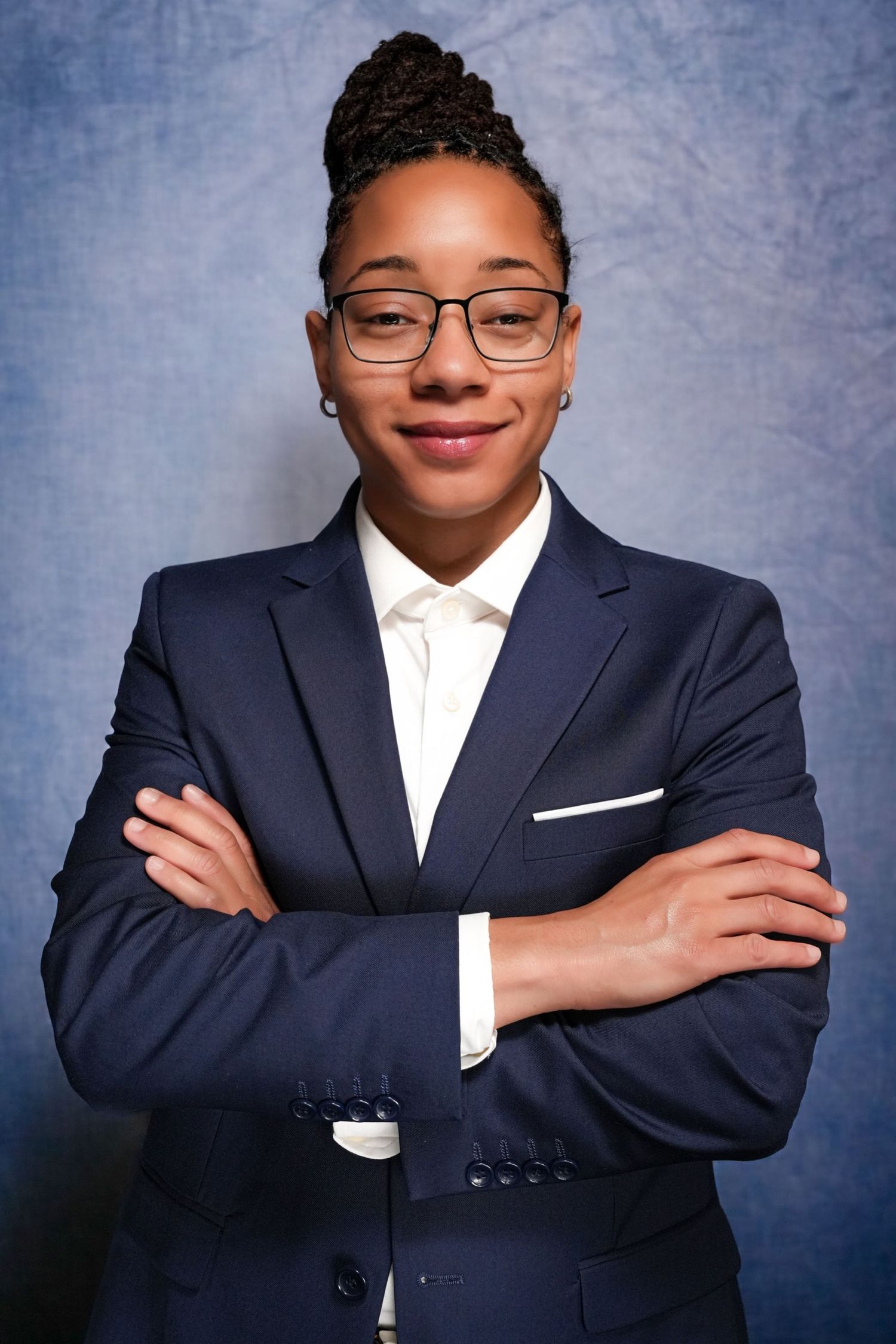 Professional portrait series showing confident poses in a navy suit and white shirt.