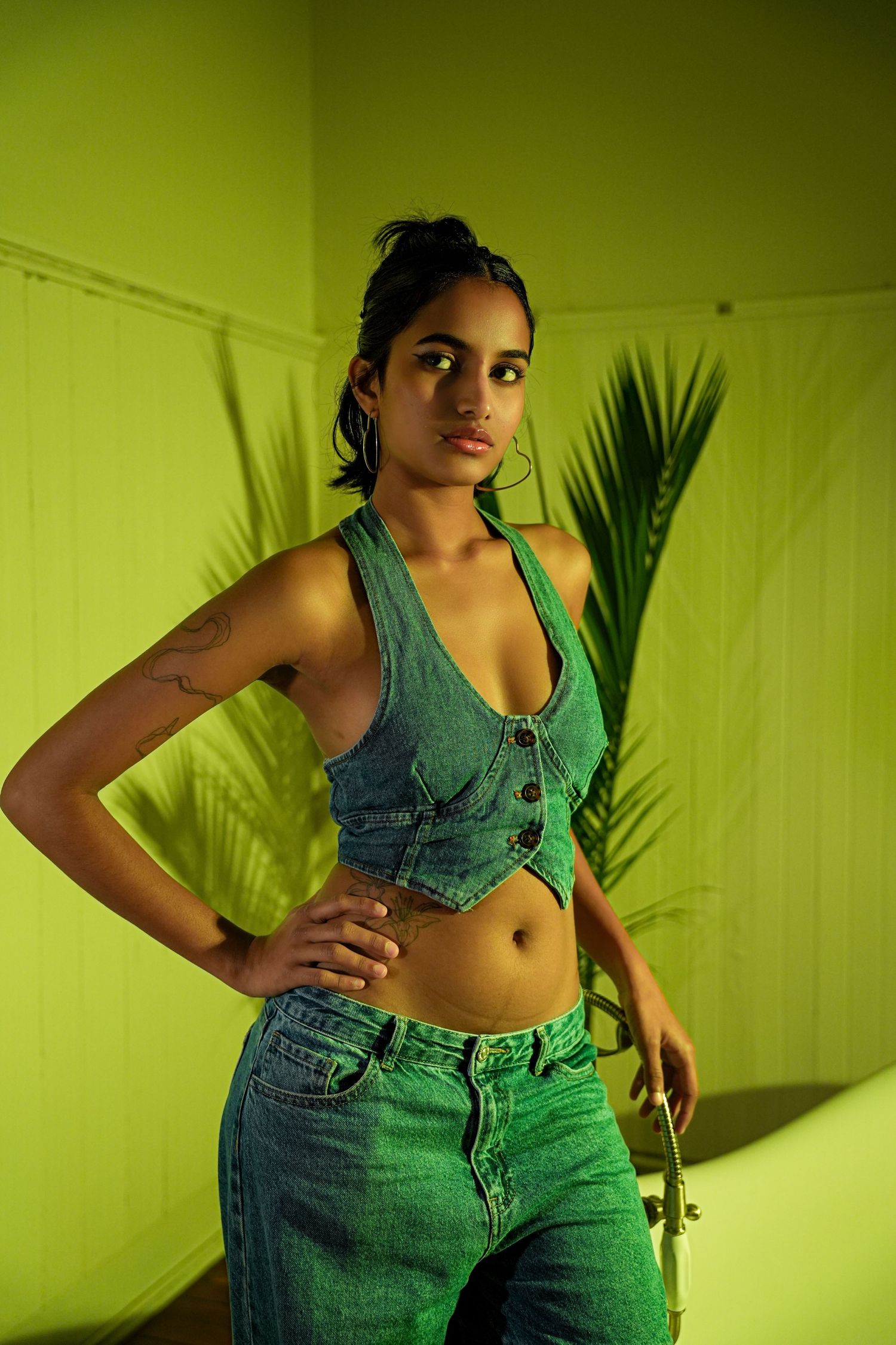 Fashion series with green lighting showing denim crop top and jeans poses.