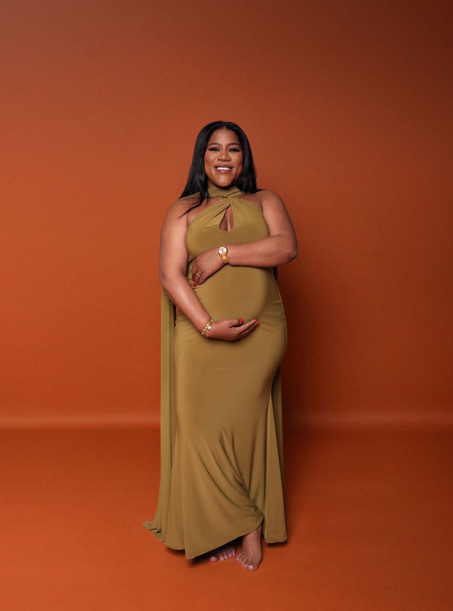 Fashion portrait series against a terracotta backdrop featuring poses in an olive dress.