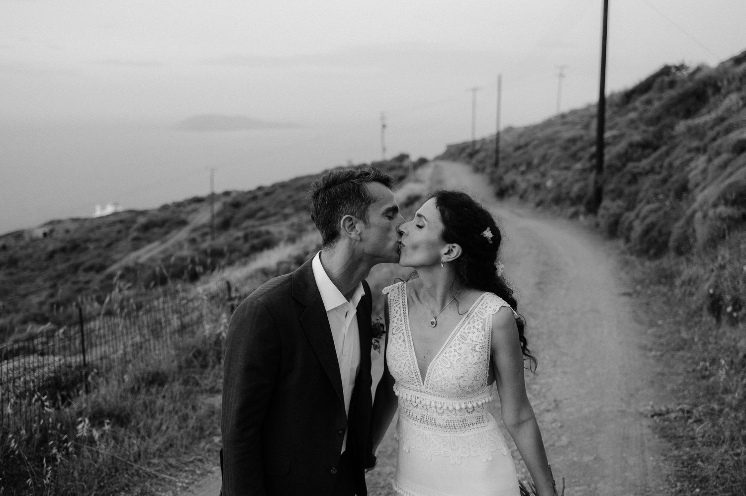 A cinematic photo of a bride and groom kissing after their non-traditional wedding in Serifos Sifnos Ios island, Greece