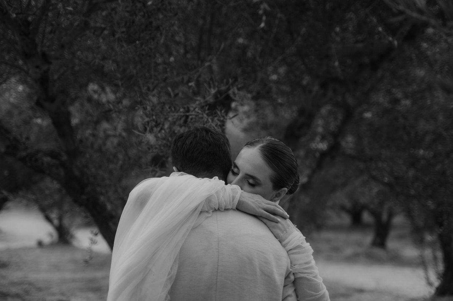 A cinematic emotional photo of a bride and groom hugging after their wedding in Crete, Greece