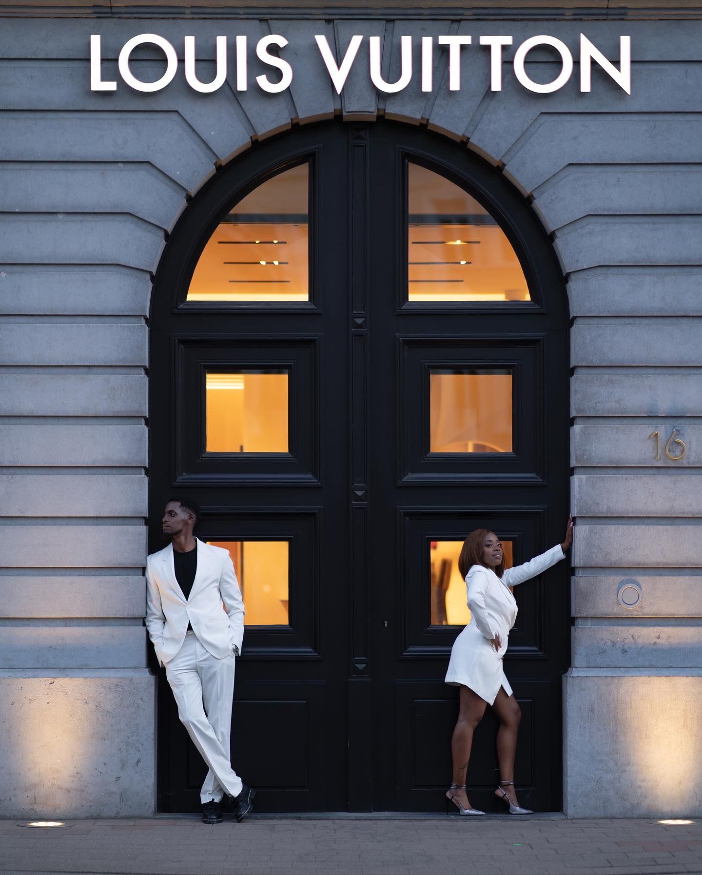 Stylish photo sequence in front of Louis Vuitton store with dramatic lighting and poses.