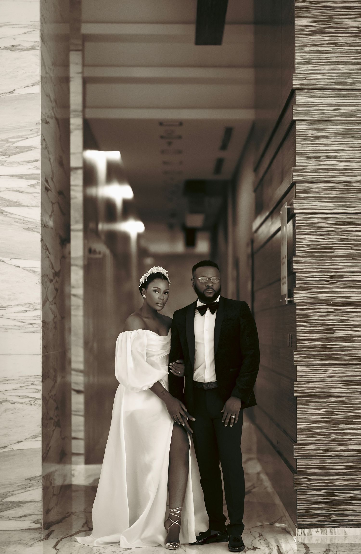 Black and white corridor photoshoot showing elegant formal attire.