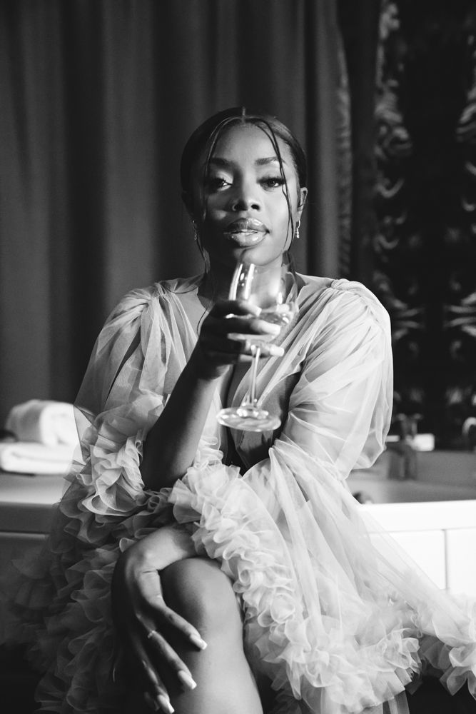 Elegant portrait series featuring a white ruffled dress against a dark background.