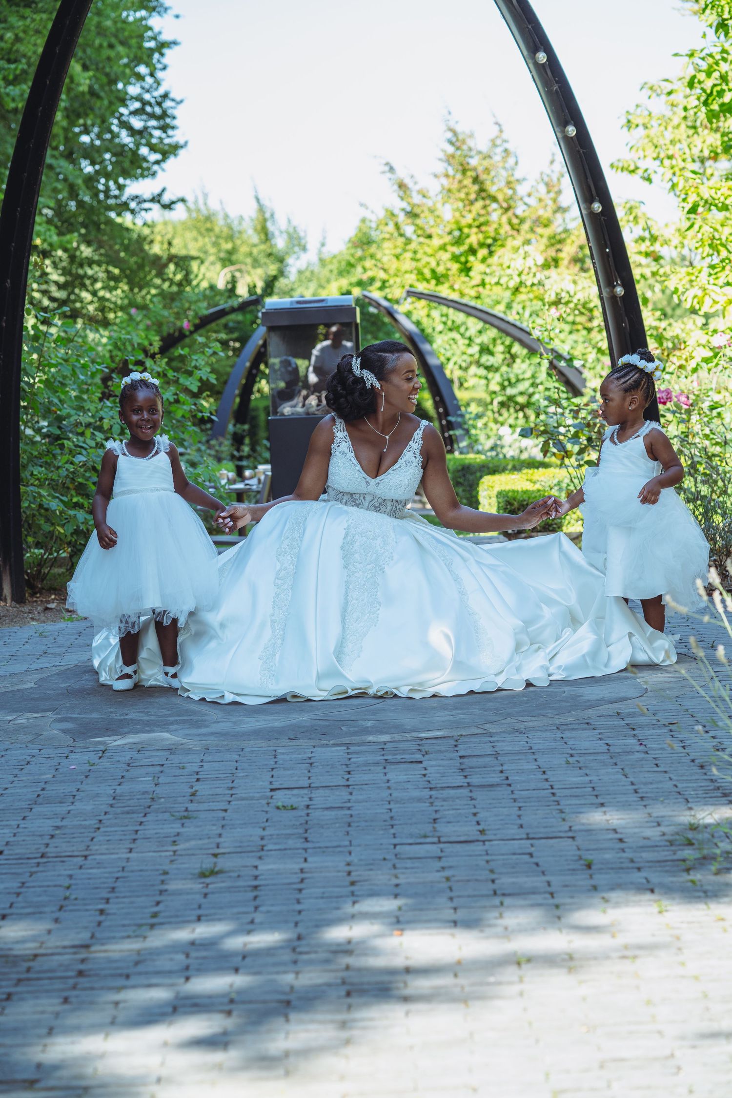 A sequence of wedding photos showing a bride in a white gown posing on a stone walkway in a garden setting.