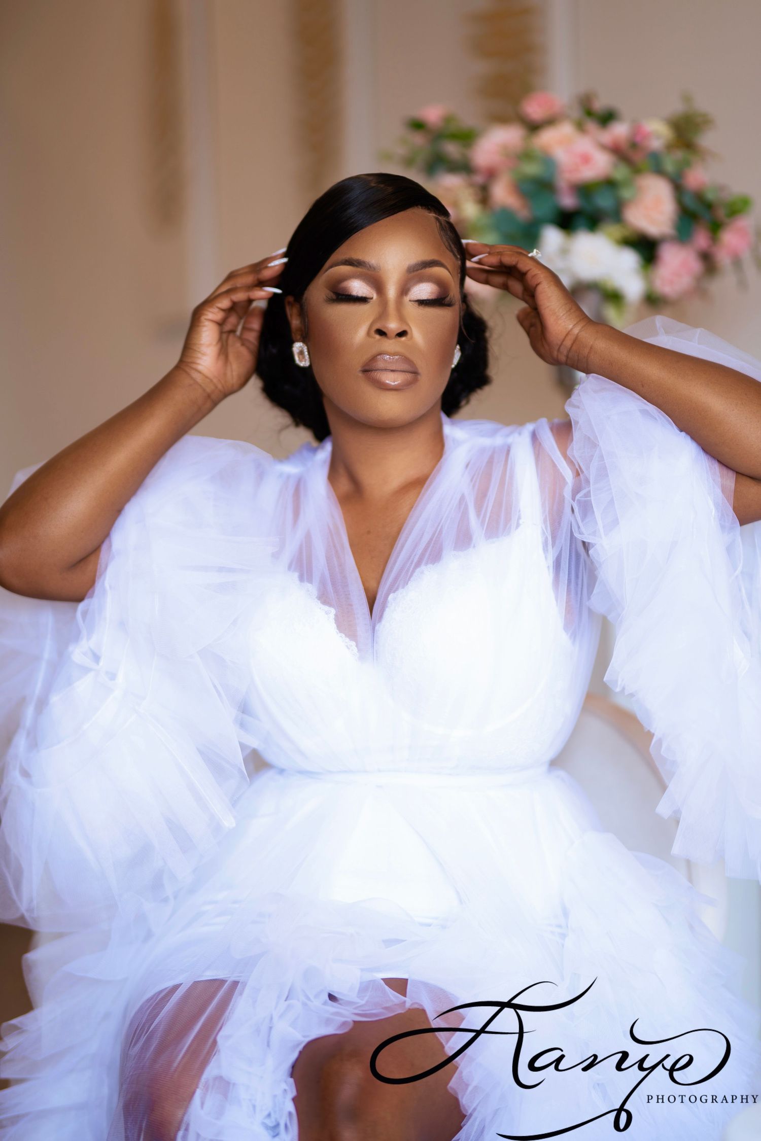 Glamorous bridal boudoir photoshoot featuring flowing white fabric and dramatic poses.