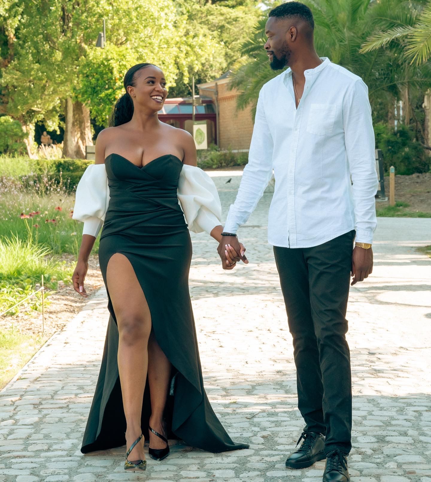 Romantic outdoor photoshoot with couple in contrasting black and white attire.