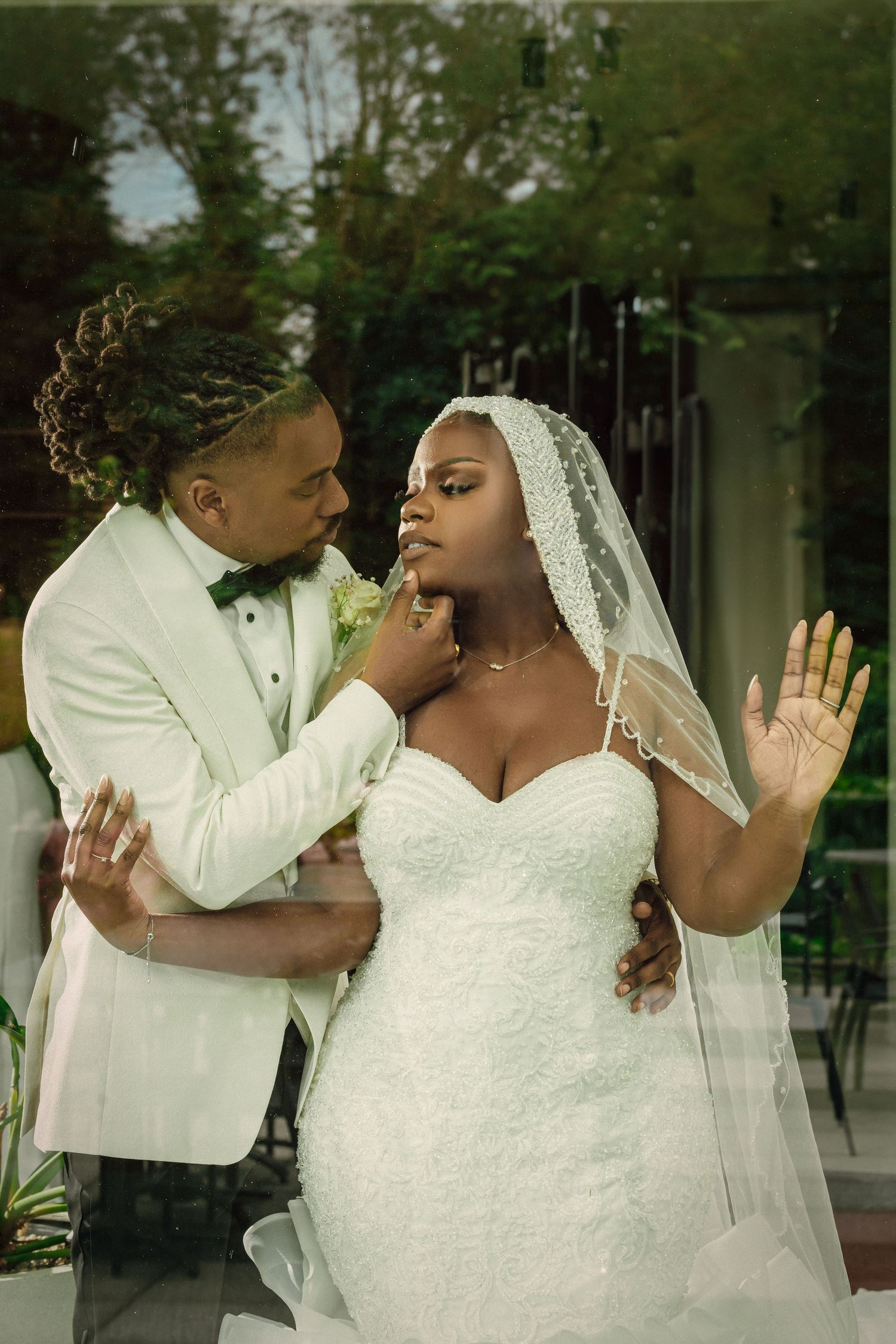 A romantic wedding couple embraces in a series of intimate poses outdoors.