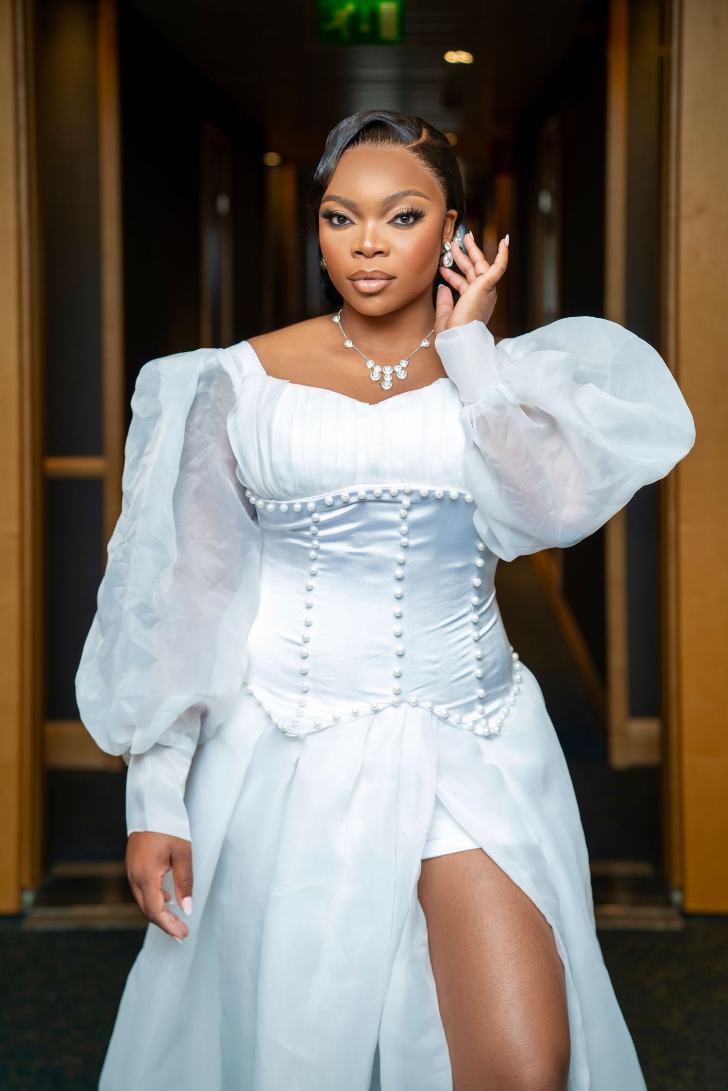Romantic bridal photoshoot featuring a white dress with puffy sleeves and pearl details.