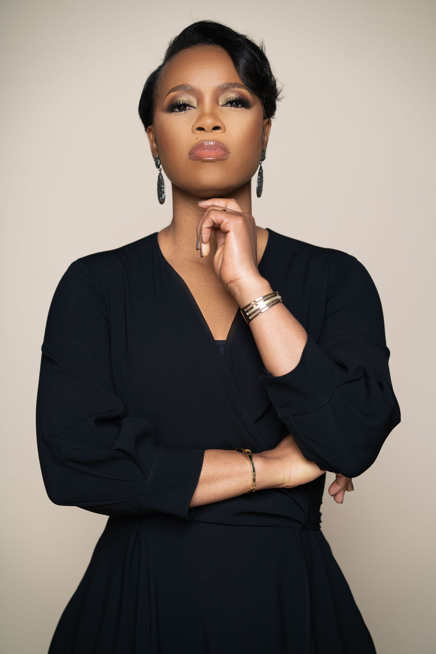 Elegant portrait series featuring poses in a sophisticated black dress against cream background.