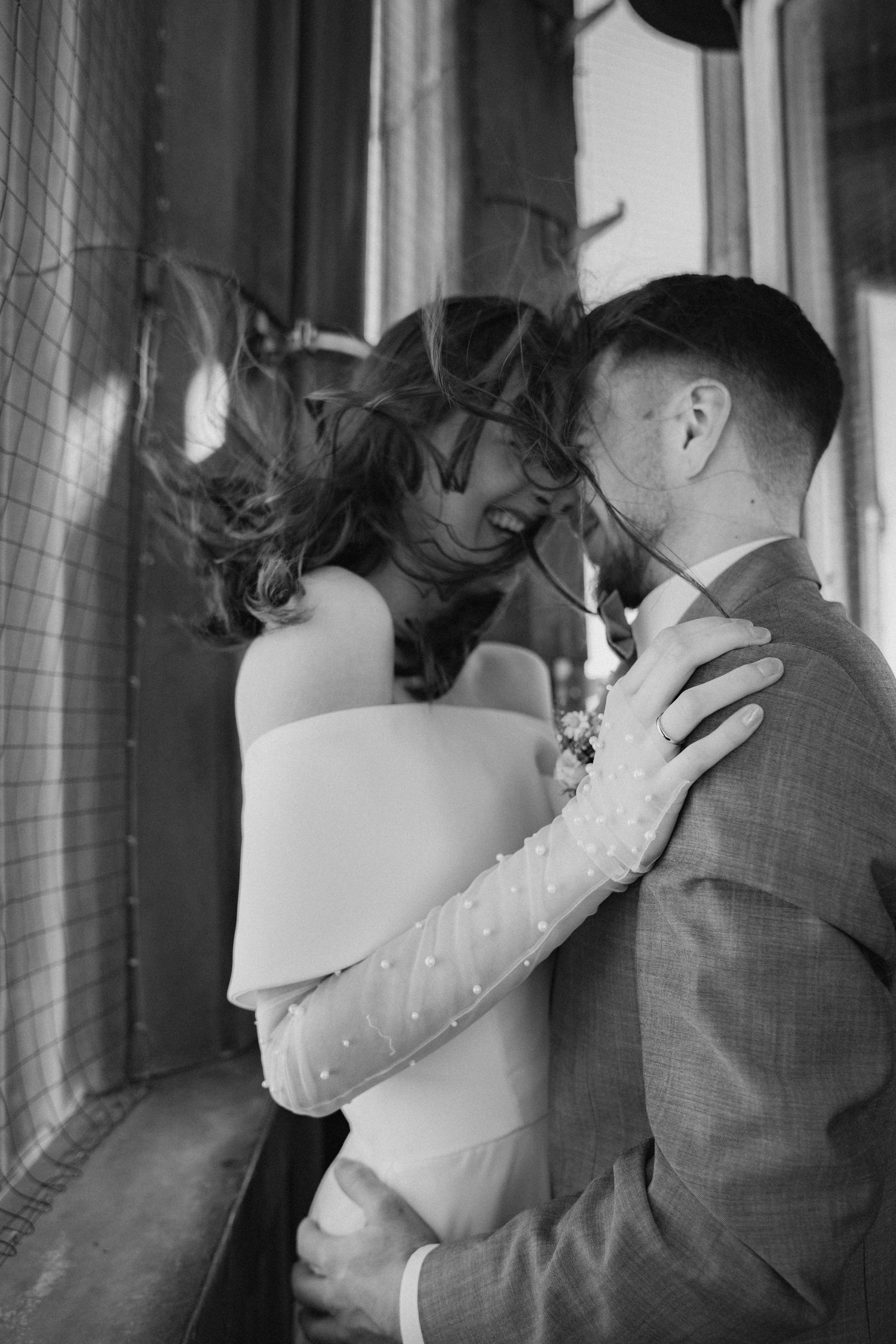 A romantic black and white wedding portrait series showing tender embraces and intimate moments.
