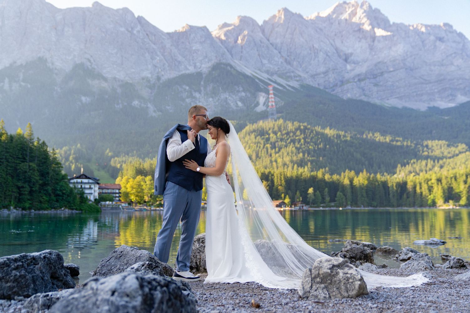 A scenic mountain wedding photoshoot at Eibsee Lake in Bavaria with dramatic Alpine peaks in the background.