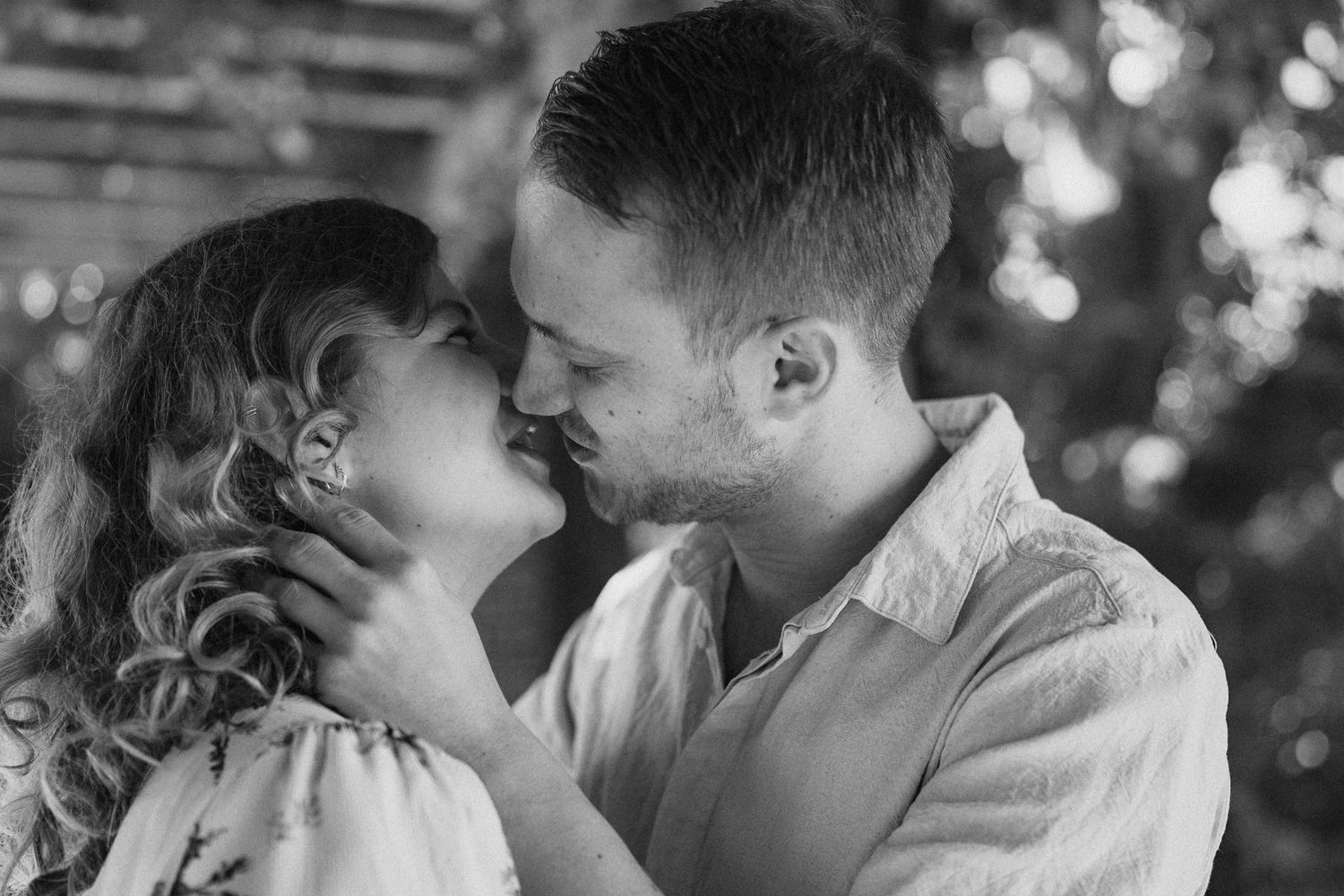Intimate black and white portraits of couple sharing tender moments.