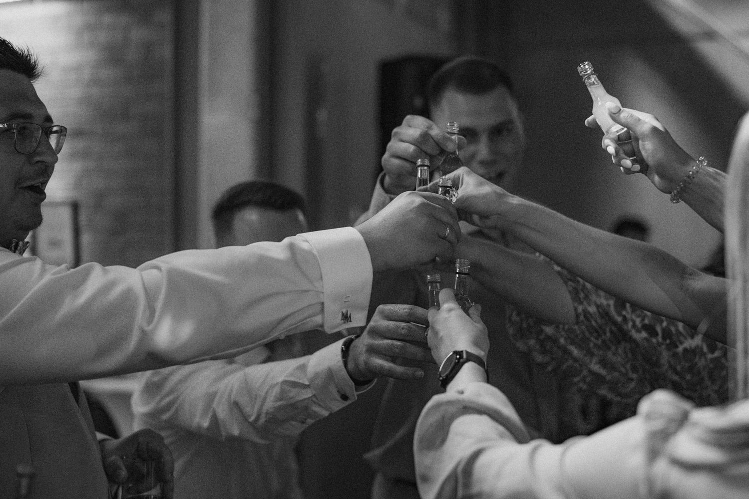 Black and white sequence showing hands reaching and connecting in an intimate moment.