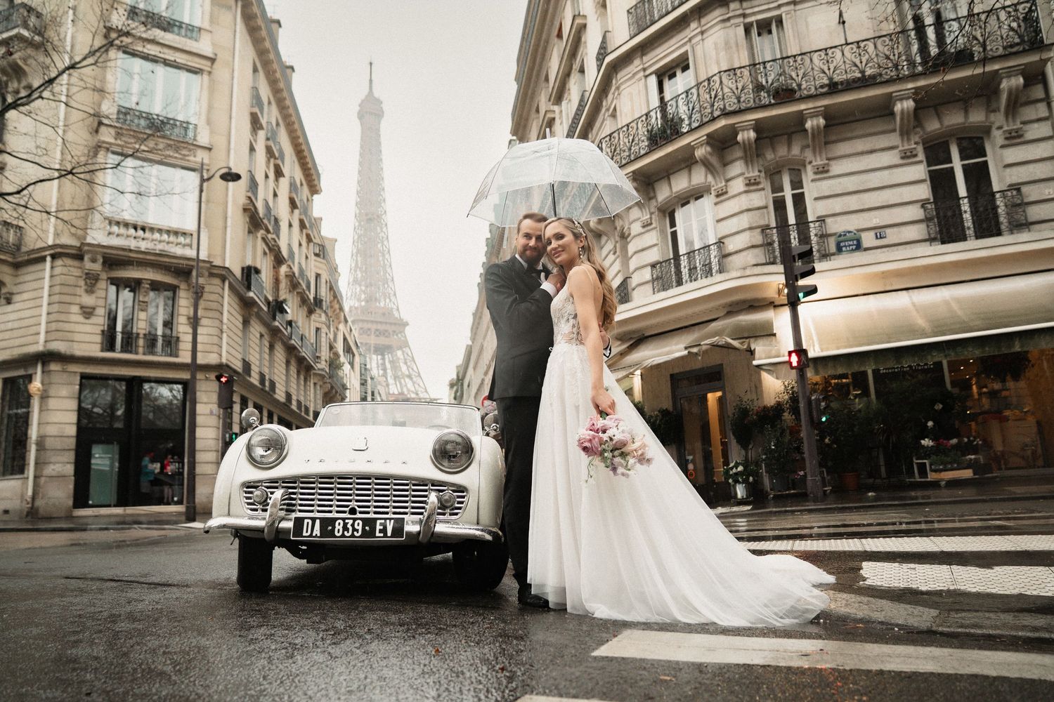 A wedding photoshoot on a charming Parisian street with the iconic Eiffel Tower visible in the background.
