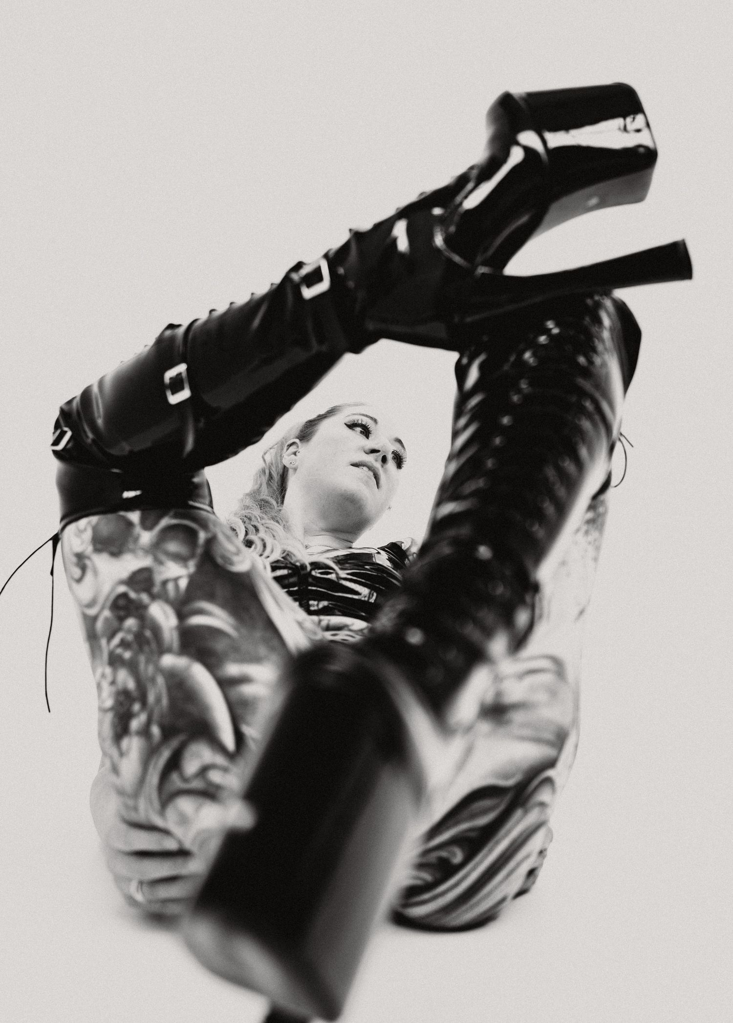 Black and white artistic photo series showing multiple angles of a high heel boot with dramatic shadows and contrast.