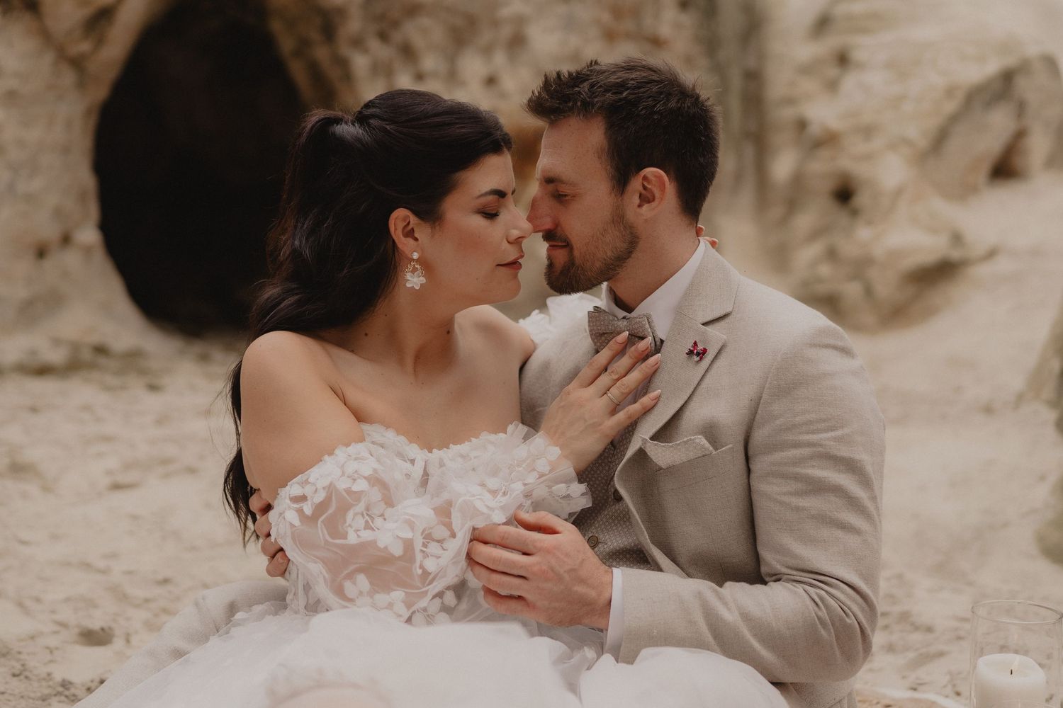 An intimate wedding portrait series capturing loving embraces between newlyweds in neutral tones.