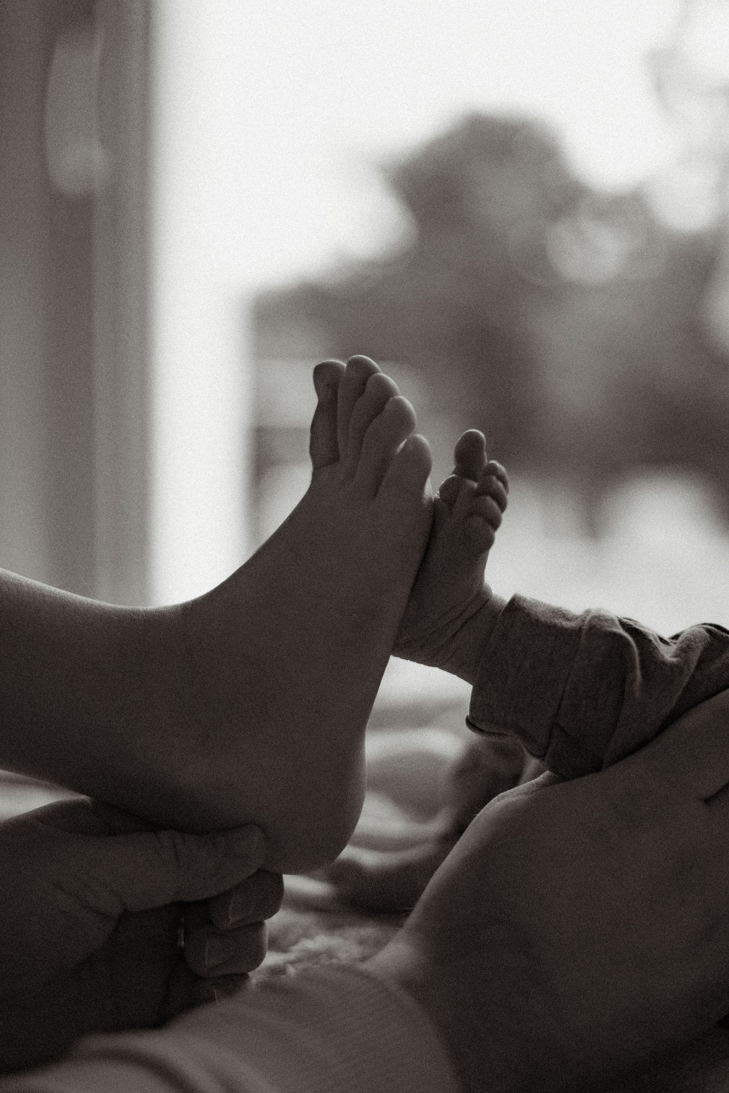 Artistic black and white photo series showing silhouetted feet against a bright window.