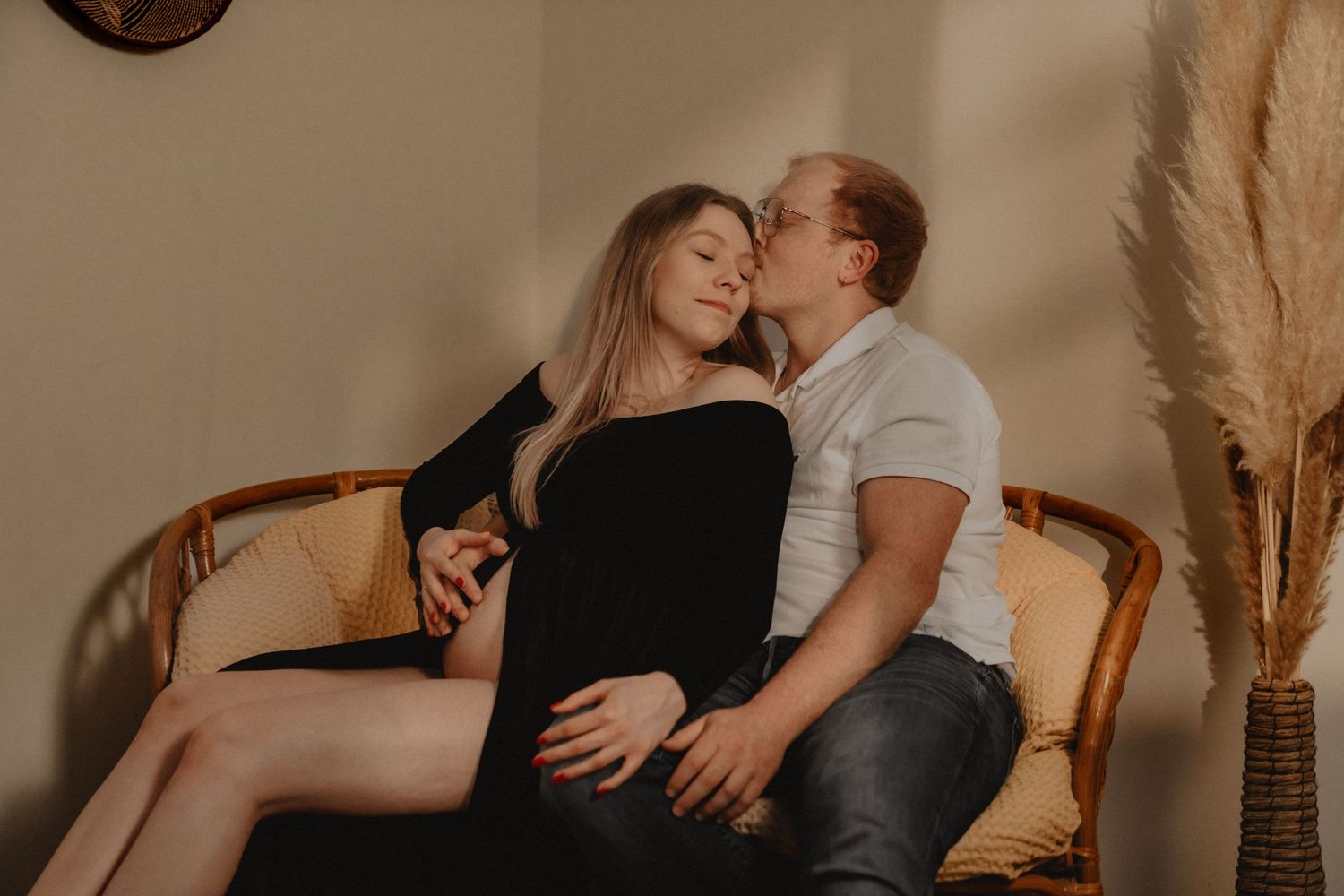 Warm-toned maternity photos showing intimate moments in home setting.