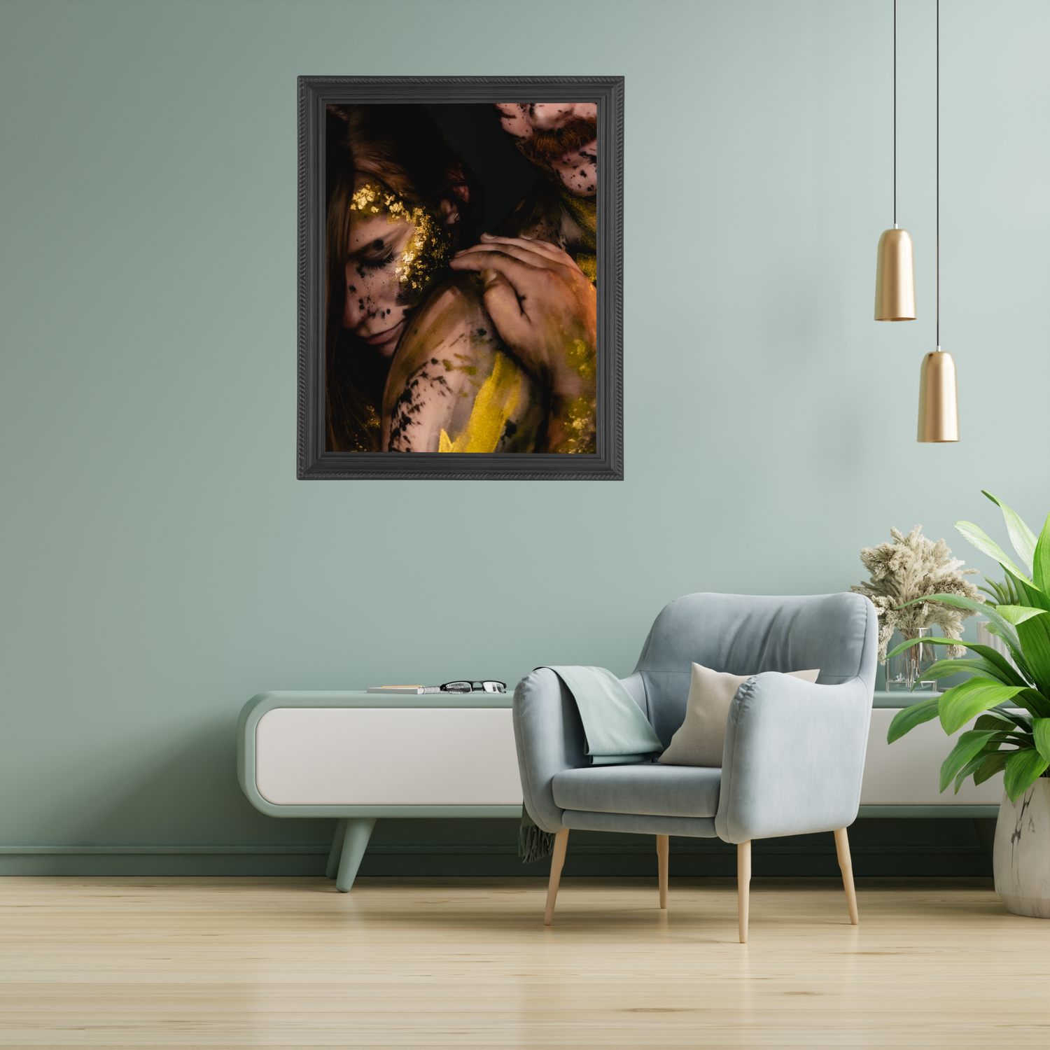 Framed wall art of a woman with gold floral makeup in a modern living room with gray chair and green walls.