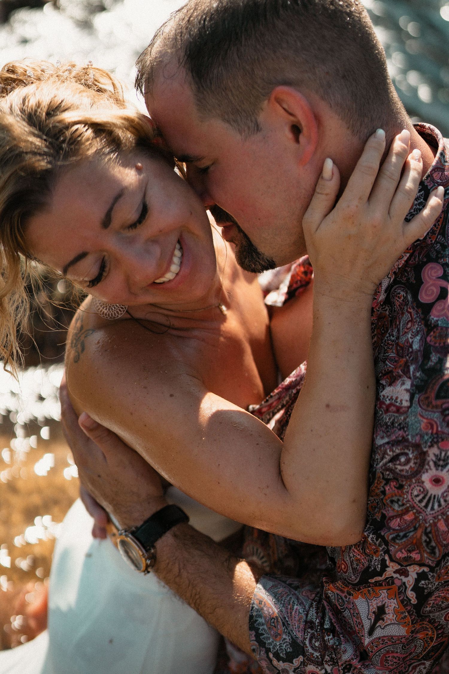 Intimate close-up of romantic moment captured in golden sunlight by the sea.