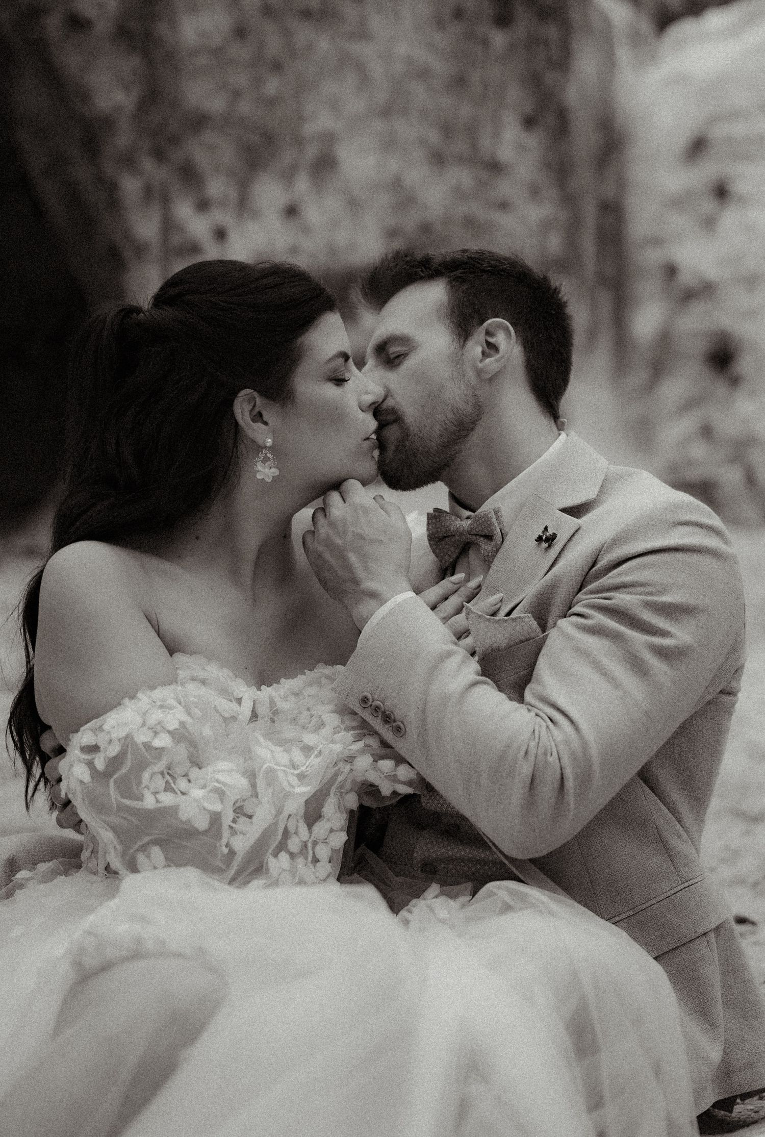 Black and white wedding photos showing romantic close-up moments between a bride and groom.
