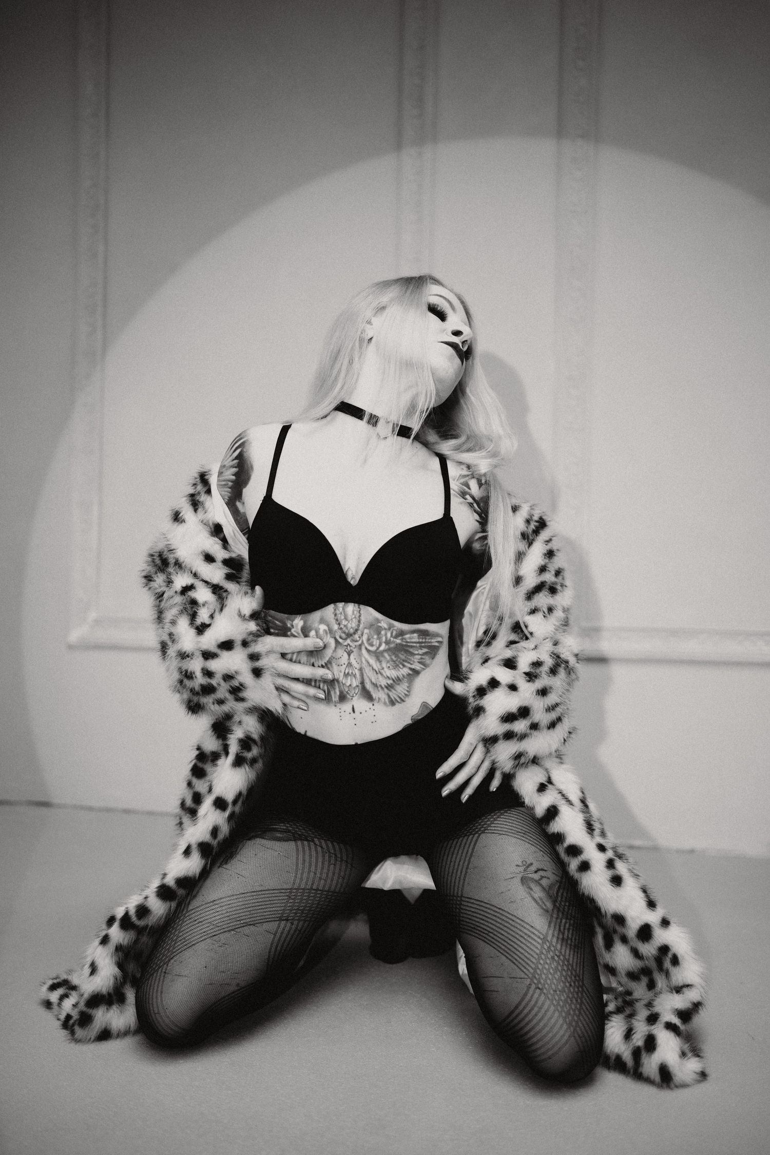 A black and white photo series showing legs in fishnet stockings and leopard print boots in various poses.