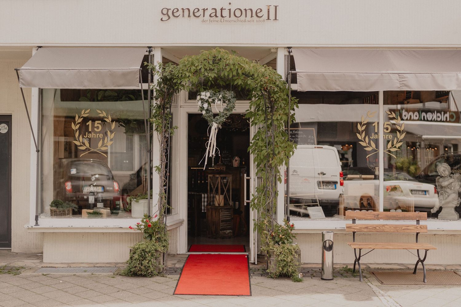 Modern storefront with red carpet entrance and clean minimalist design.