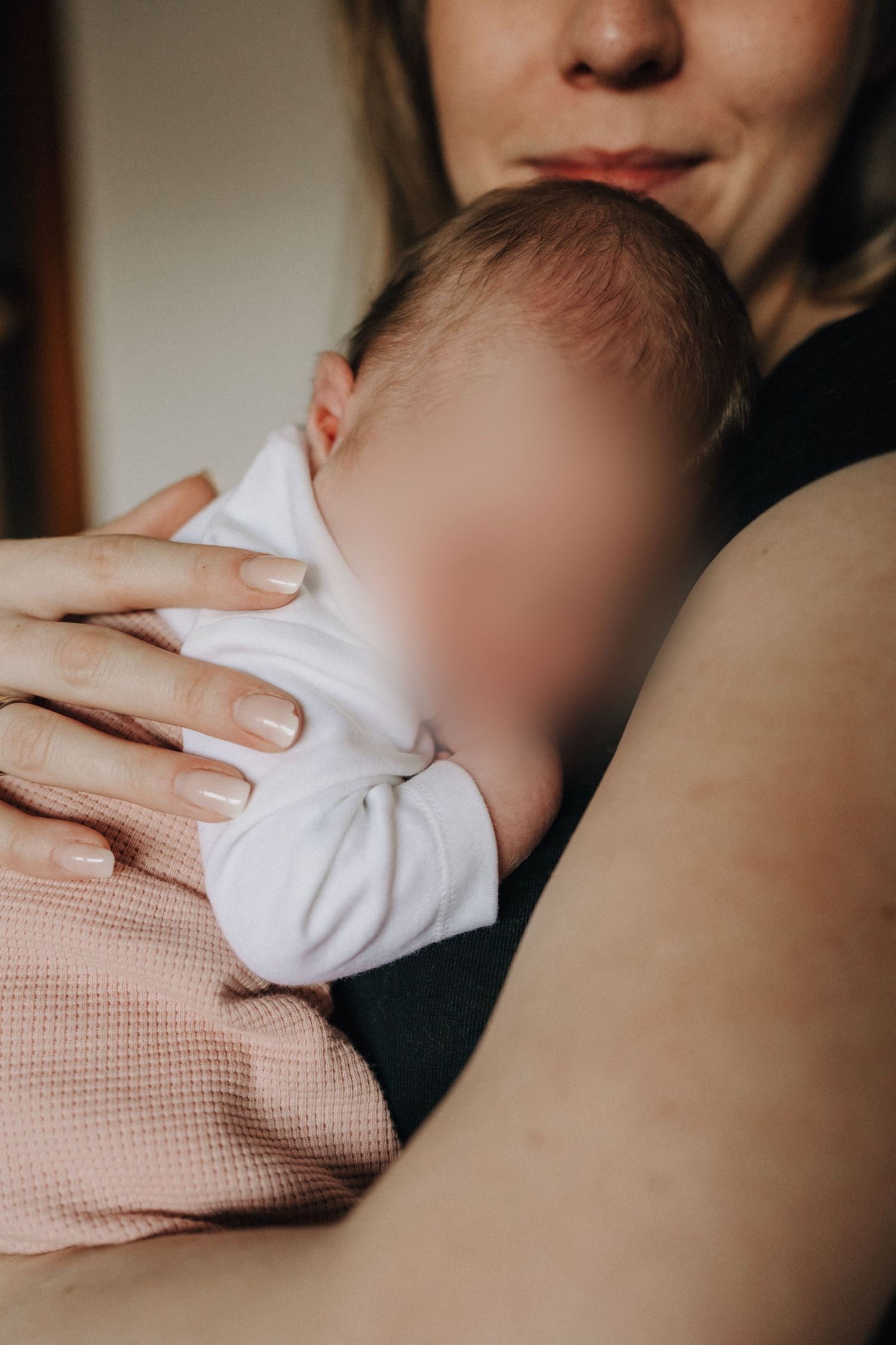 A series of intimate close-up photos showing gentle skin-to-skin contact between parent and baby in soft lighting.