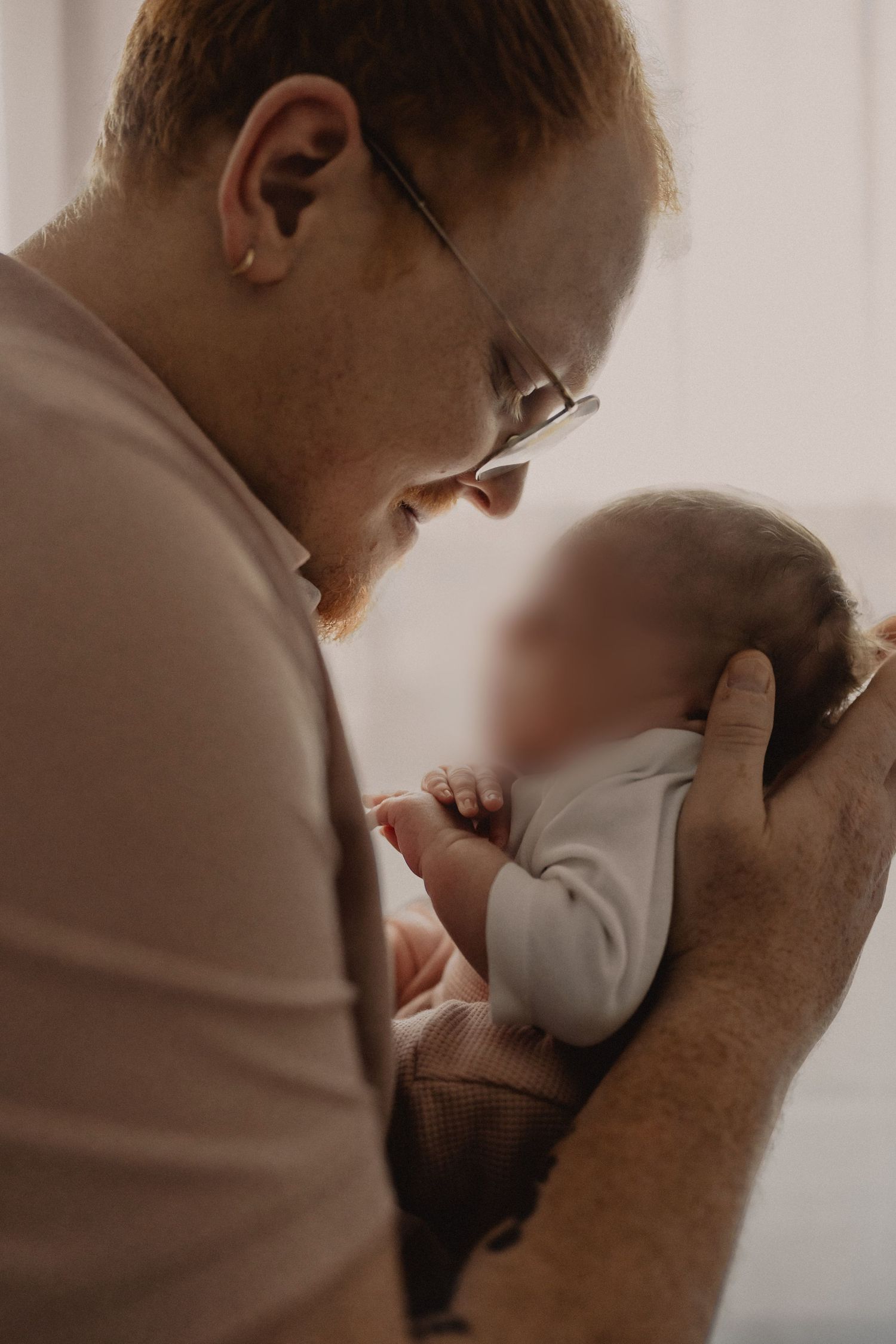 A series of intimate black and white photographs showing tender moments between parent and child.