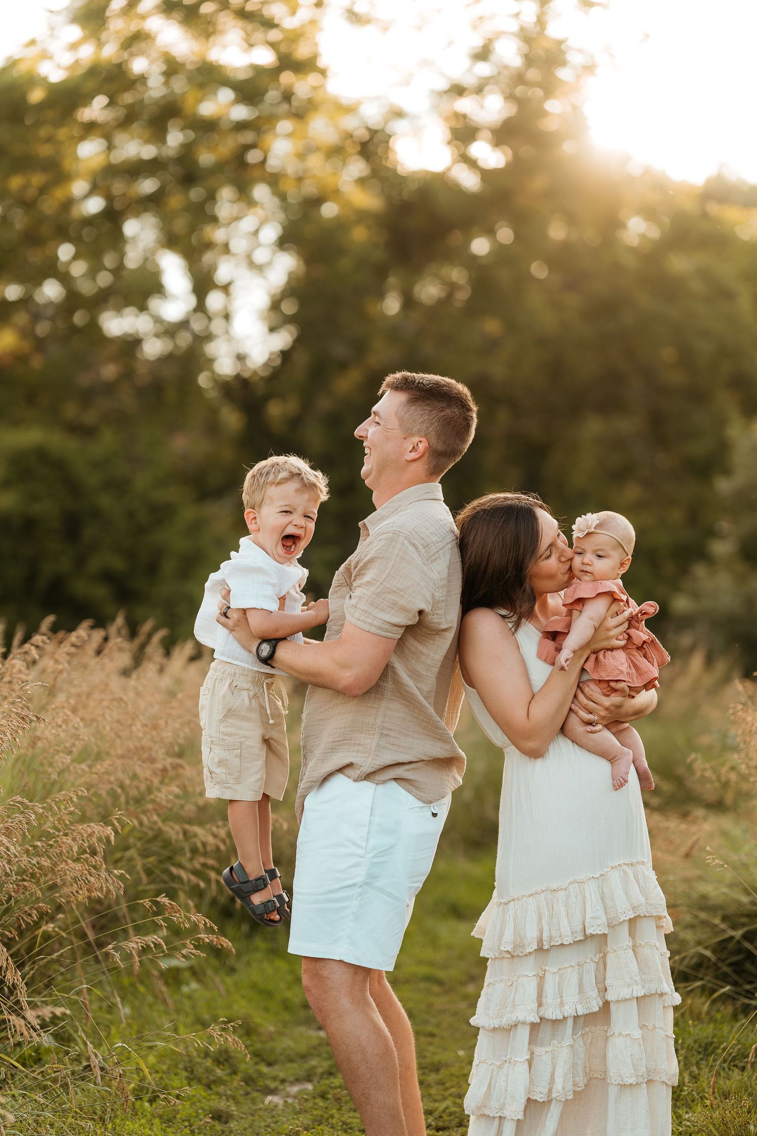 Lake Country WI family photographer capturing candid sunset moments in open field