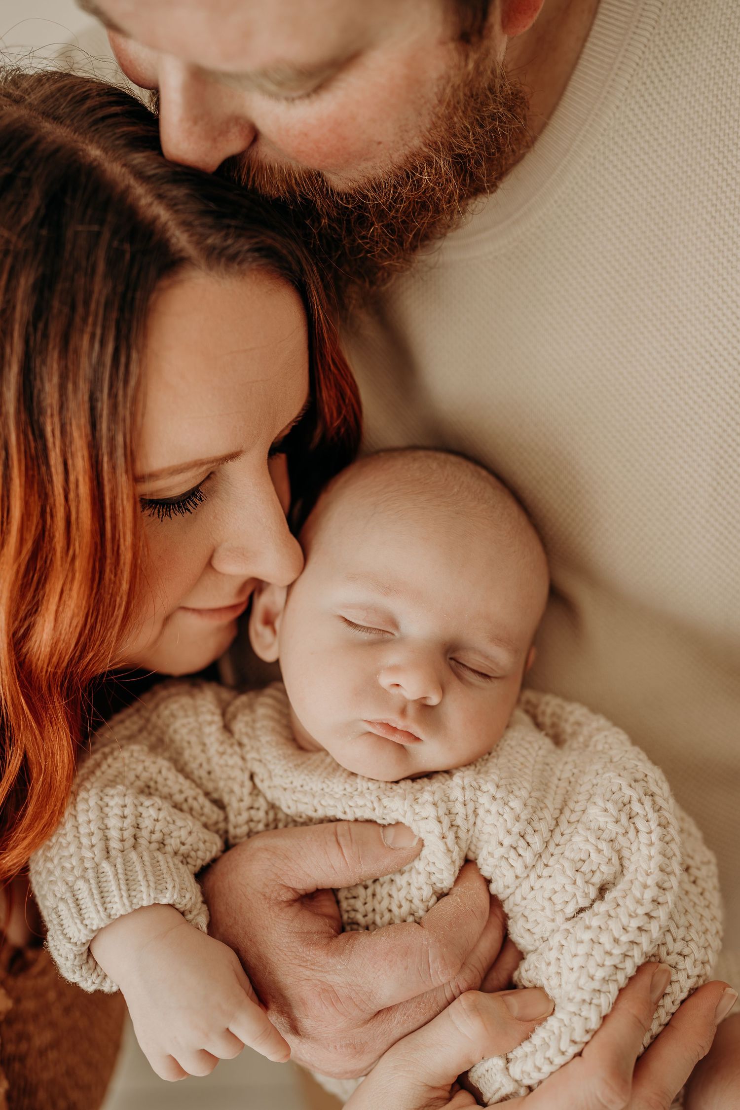 Newborn baby wrapped in neutral tones during studio session in East Troy, WI