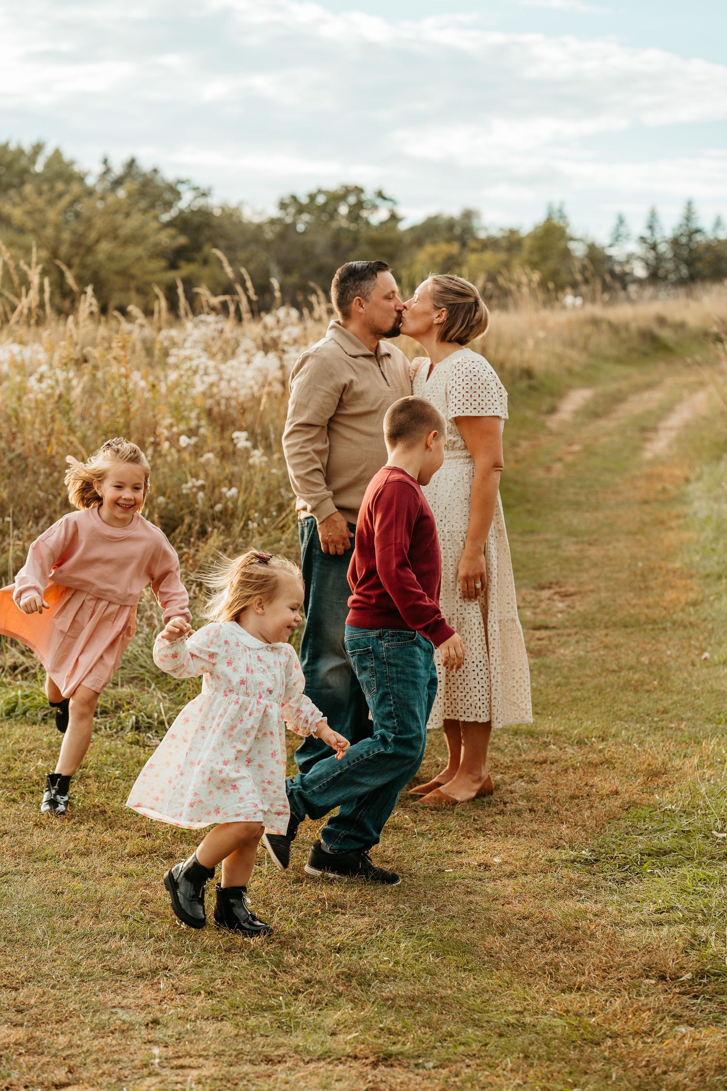 Lake Country WI family session with kids running through tall grass at sunset
