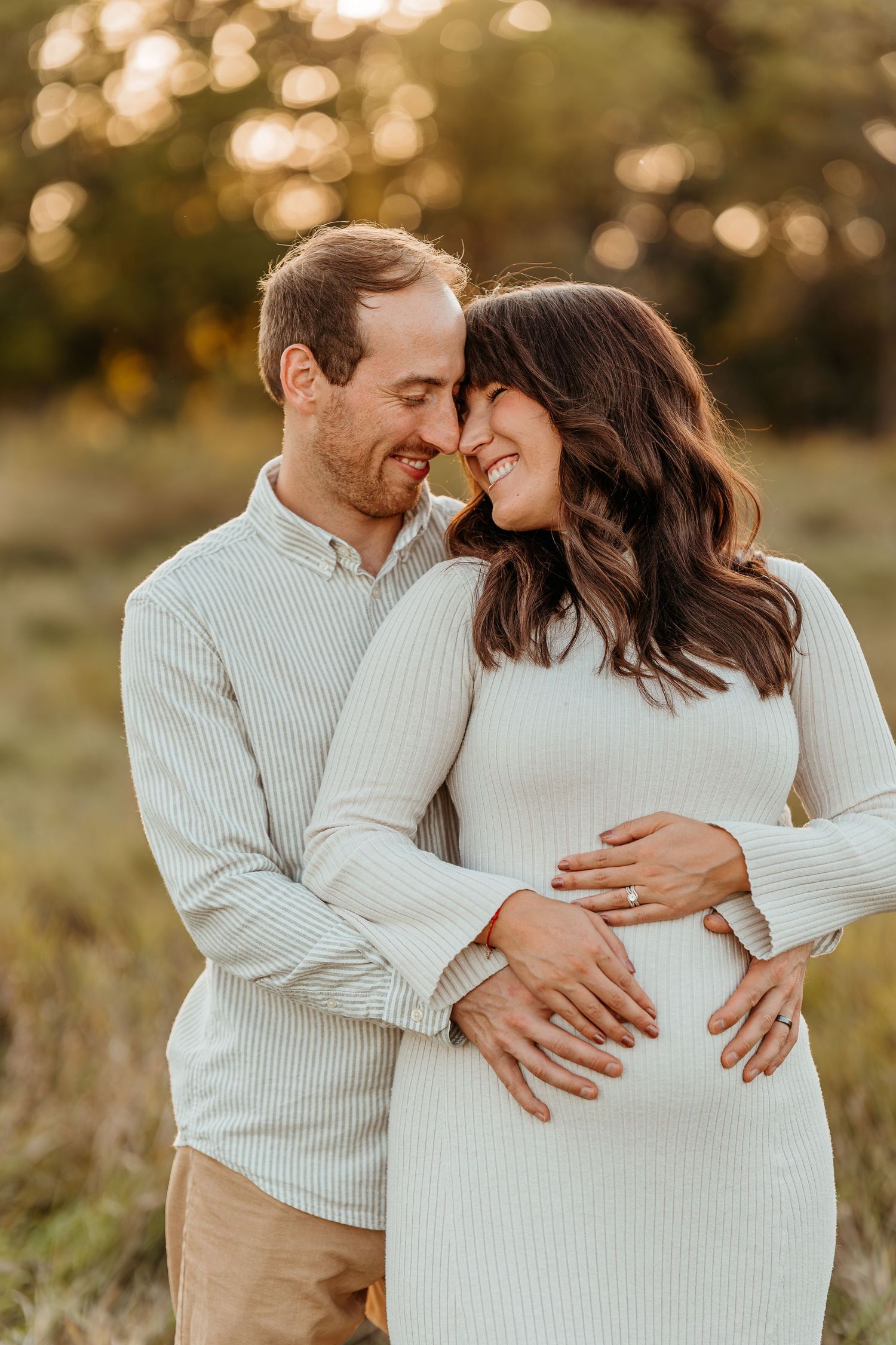 Lake Country WI sunset maternity portraits father to be placing his hand on a growing bump