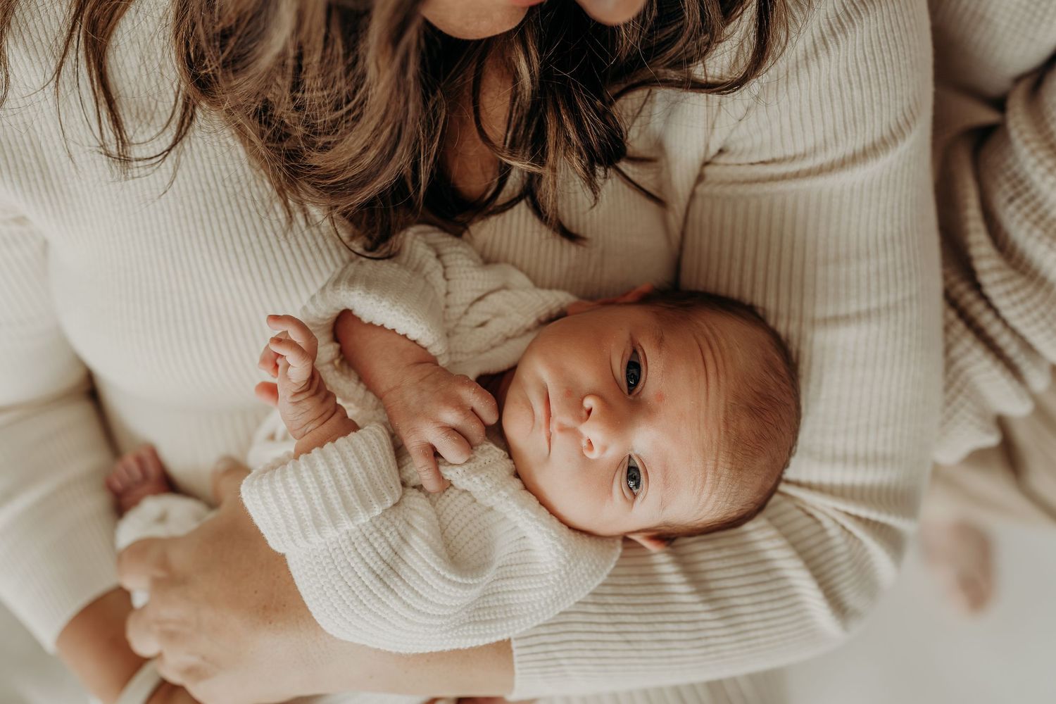 Newborn baby wrapped in neutral tones during studio session in East Troy, WI
