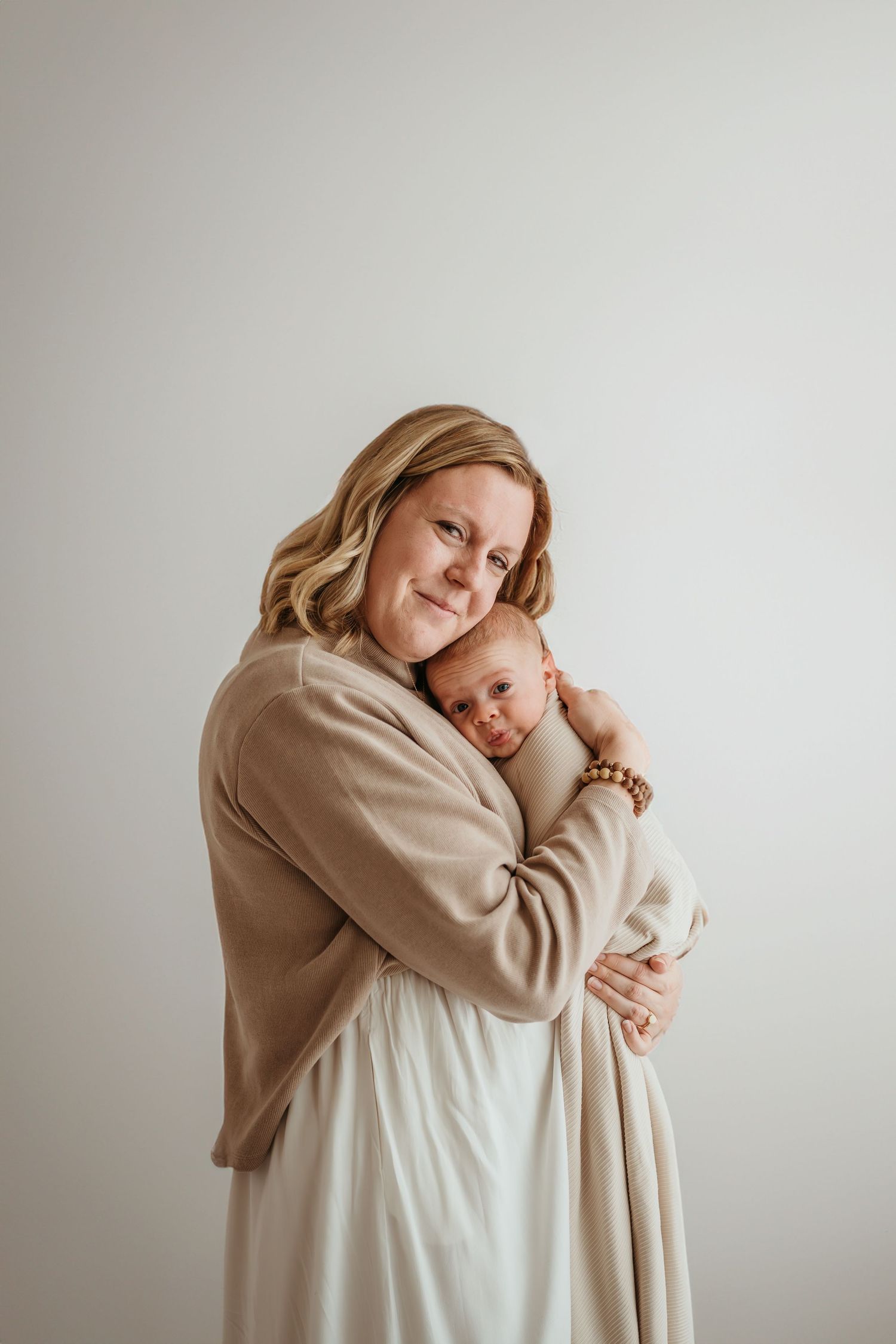 Parents holding newborn baby at Slate Studio in East Troy, WI