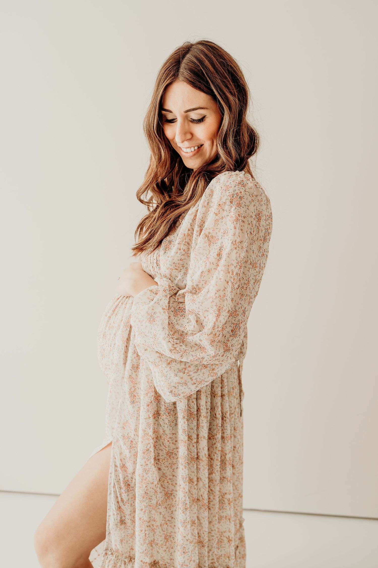 Maternity session featuring a floral dress in soft beige tones from Blank Slate Photography client closet