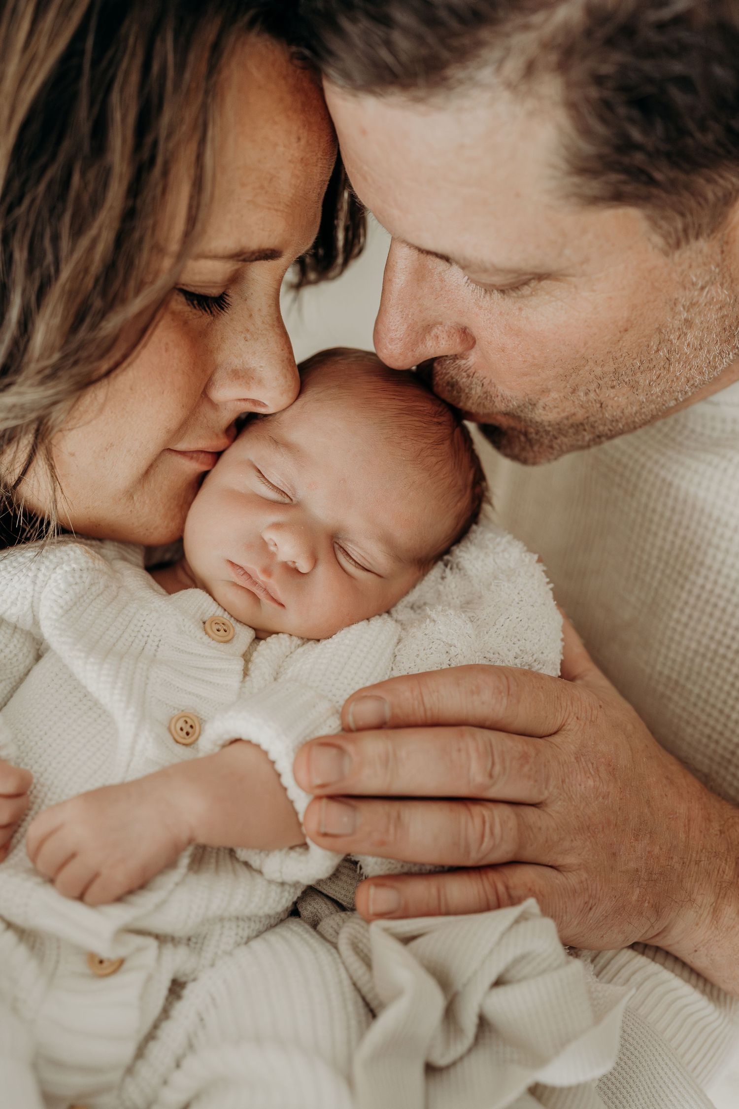 Parents holding newborn baby at Slate Studio in East Troy, WI