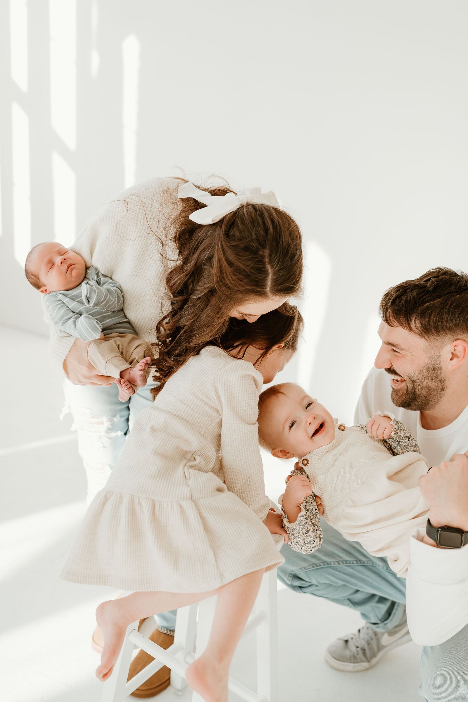 Family with newborn baby in a bright studio in East Troy, Wisconsin