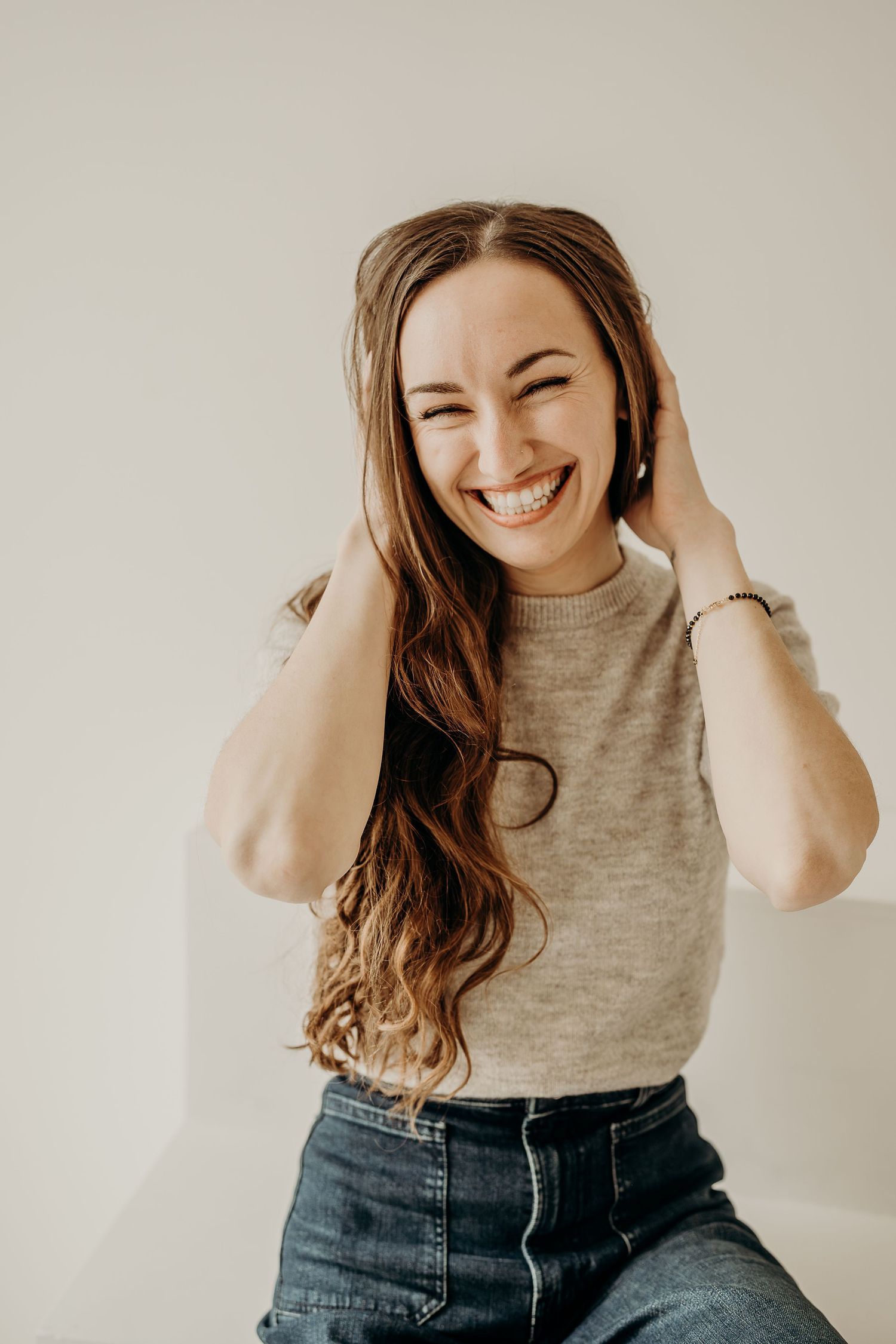 A series of lifestyle portraits showing joyful expressions against a light background with makeup done by Cassie