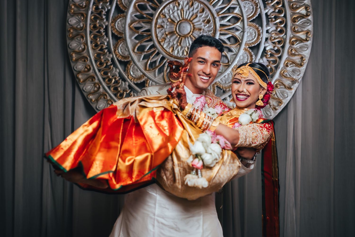 Groom lifting bride playfully, joyful wedding moment Singapore