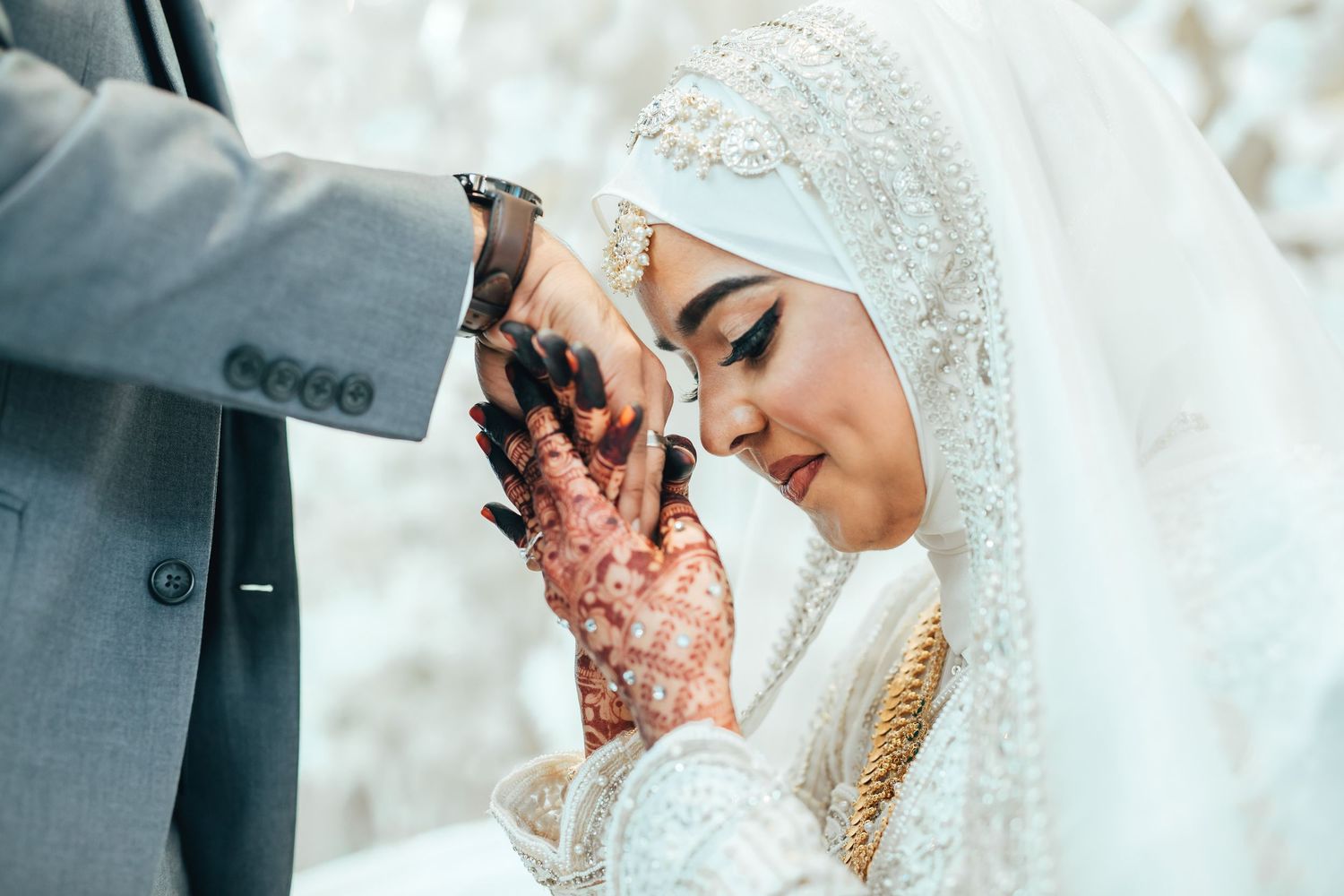 Bride in hijab during wedding ritual, emotional close-up moment