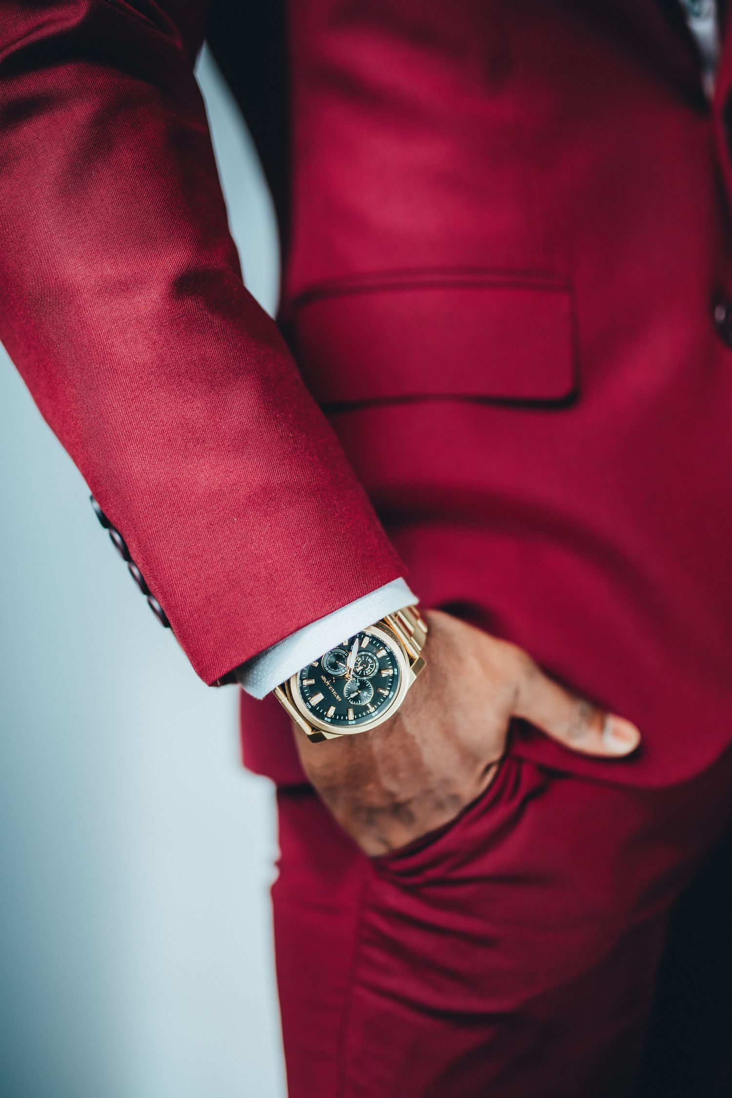 Groom suit detail with watch close-up, luxury wedding styling