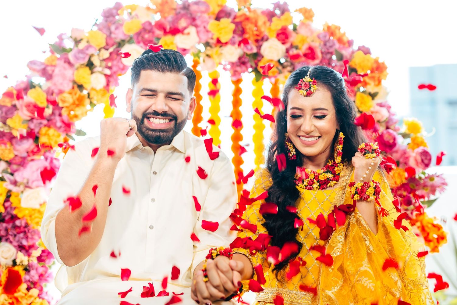 Haldi ceremony couple with turmeric and flowers, vibrant Indian wedding Singapore