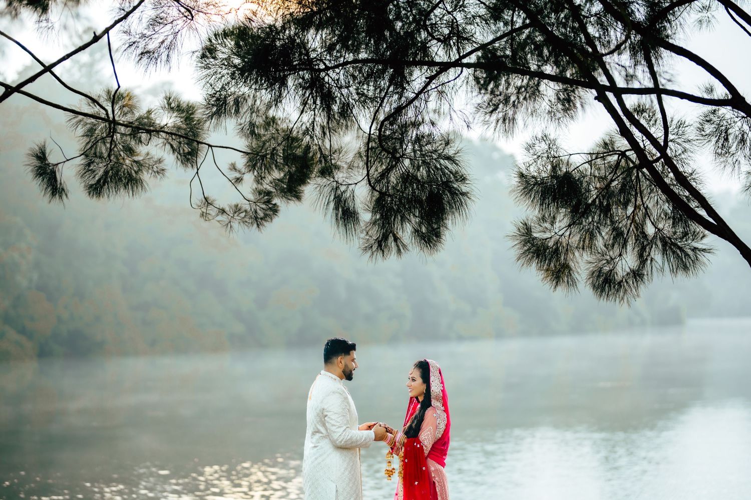 Couple standing by lake with scenic background, pre wedding photography Singapore