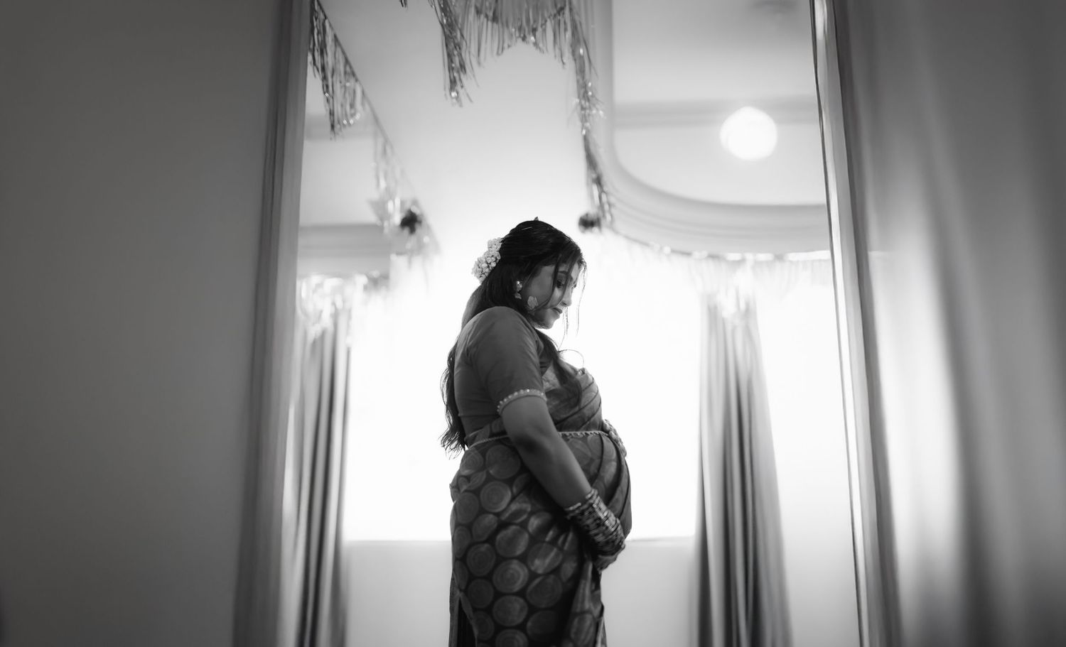 Maternity portrait of expecting mother in soft lighting, baby shower photography